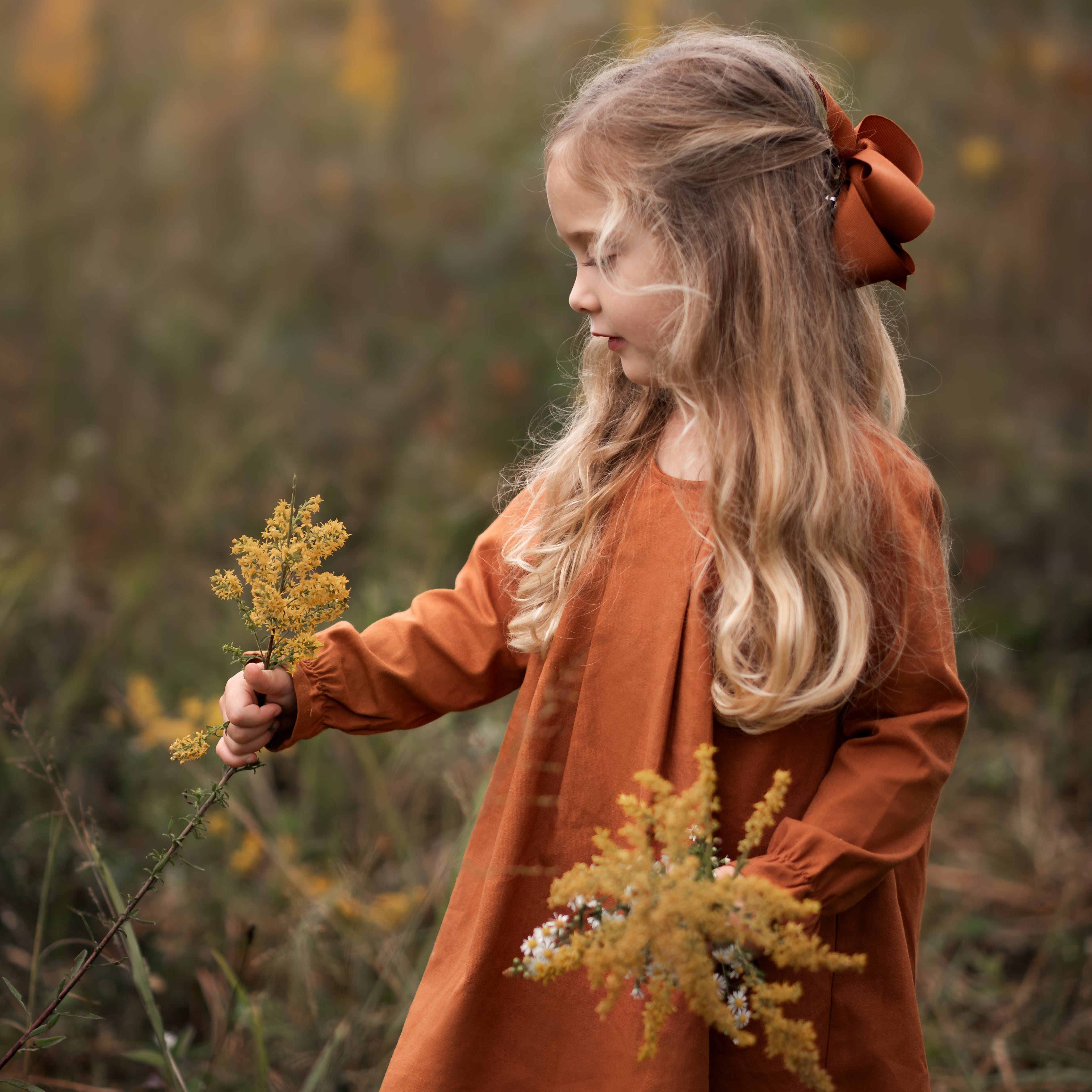 Model girl showcasing the front view of the dress - This image features a model wearing the dress from the front, highlighting the pin-tucked details and the flattering A-line shape.