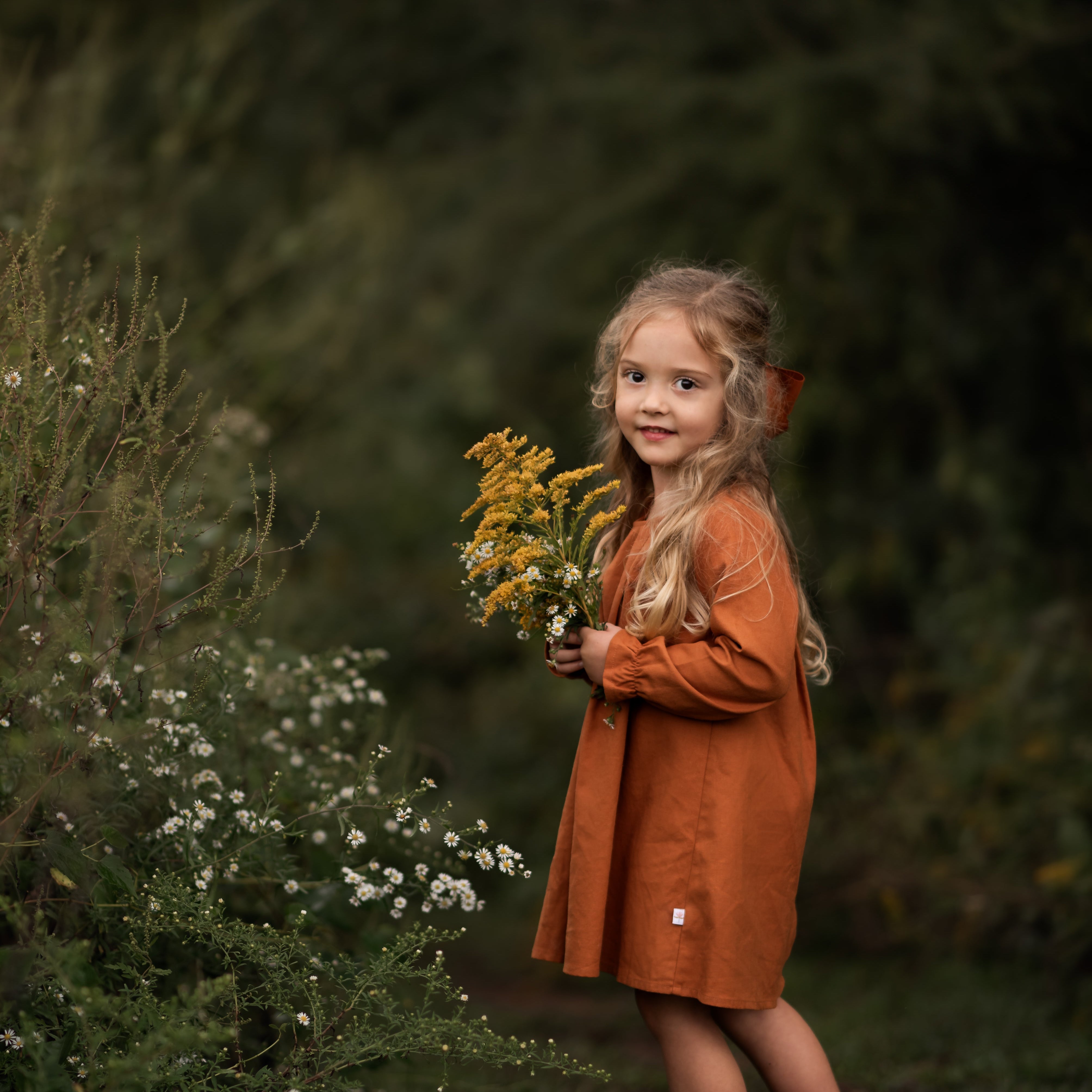 Model girl showcasing the dress in a twirl - This dynamic image features the model twirling in the dress, emphasizing its movement and the flattering A-line shape, as well as the overall elegance of the design.