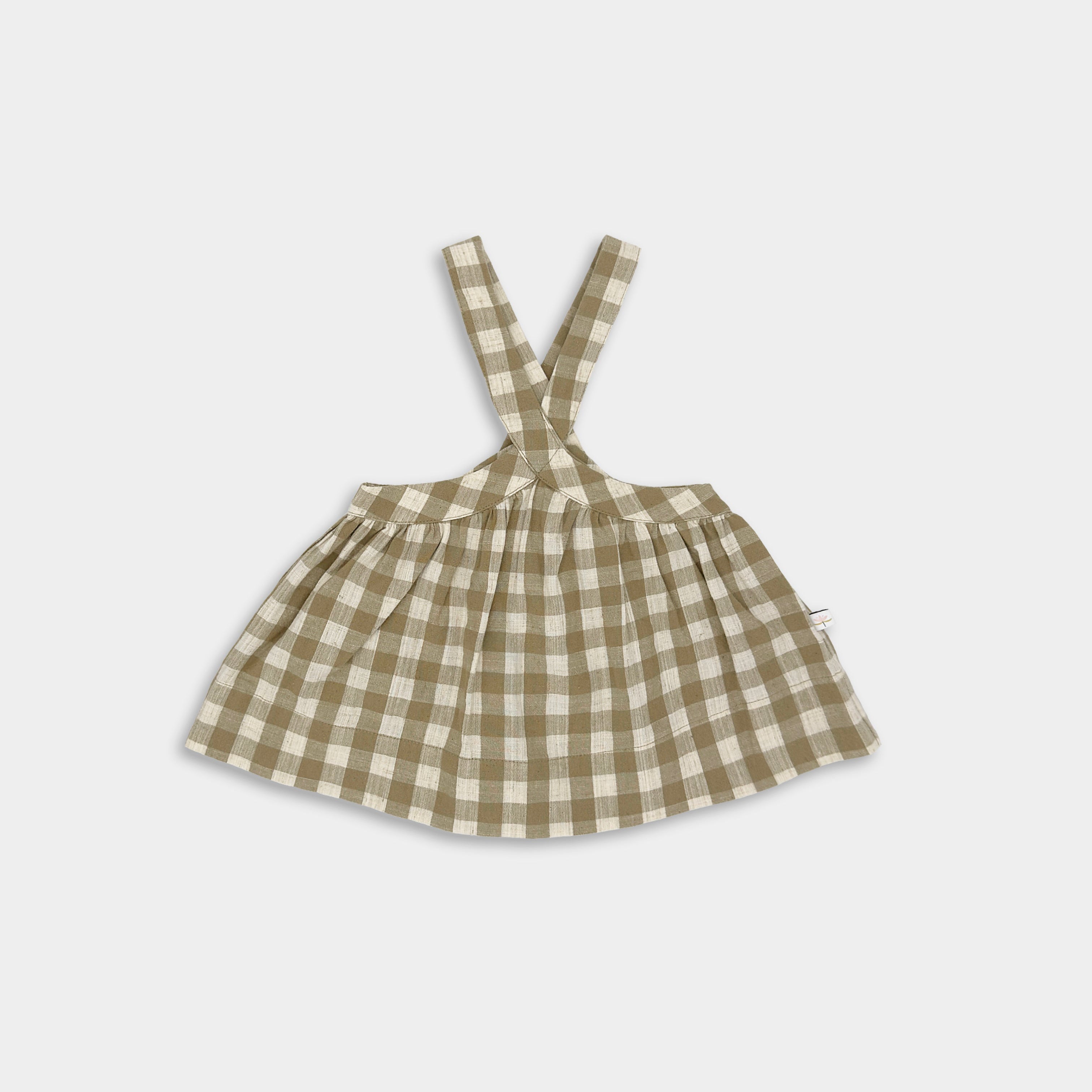 Front view of Beige Gingham Pinafore made from high-quality linen, featuring a unique design with adjustable high-waist straps for a cute vintage-inspired fit, built to last with an extra 2" of hem allowance for growth, V-shaped straps to keep them securely on the shoulders, and adjustable straps available in three lengths for layering and continued growth.