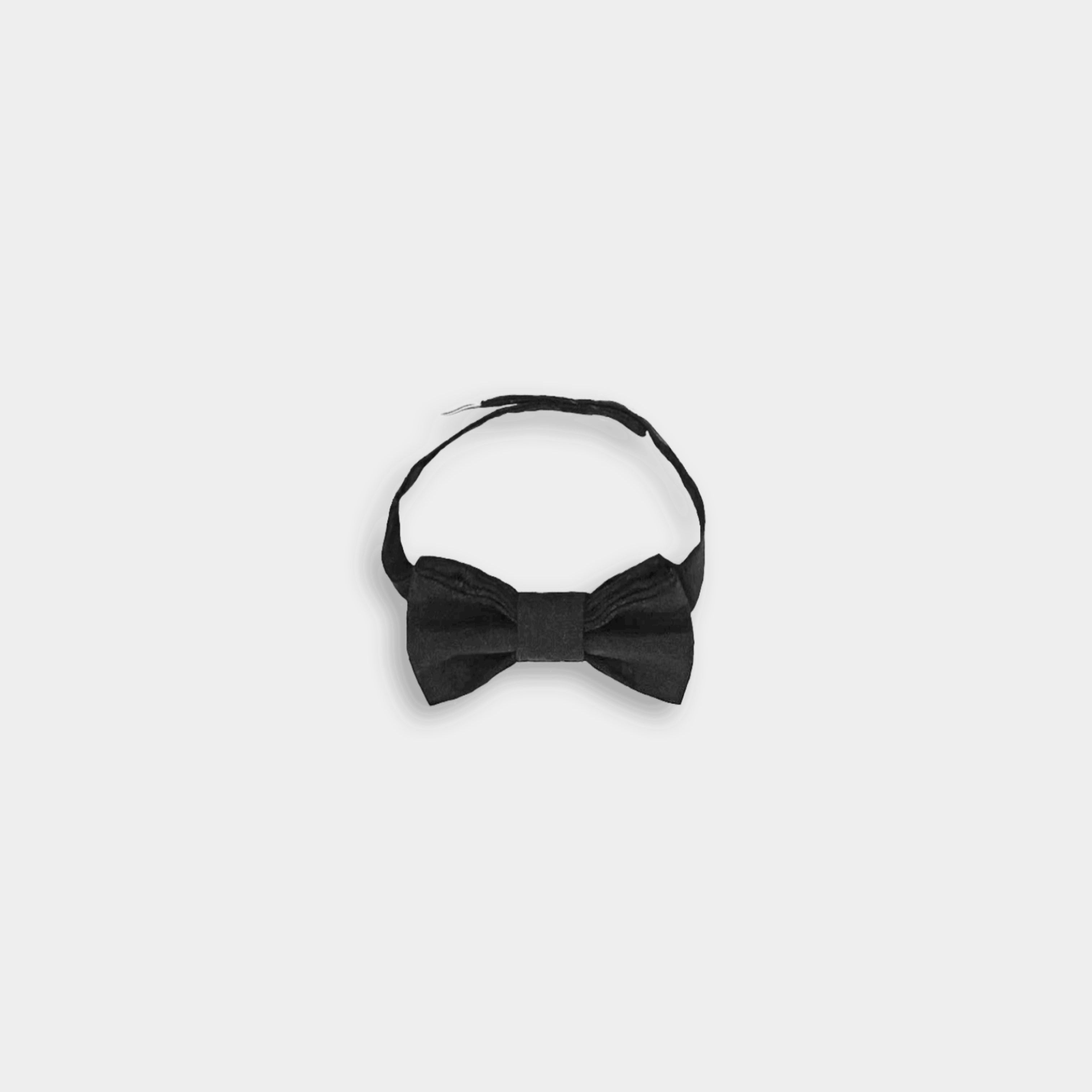 Details of A black linen classic bow tie, featuring a timeless design, versatile for various outfits, available in two sizes for wearing over a shirt or on its own, and perfectly complementing bestselling suspender shorts and overalls.