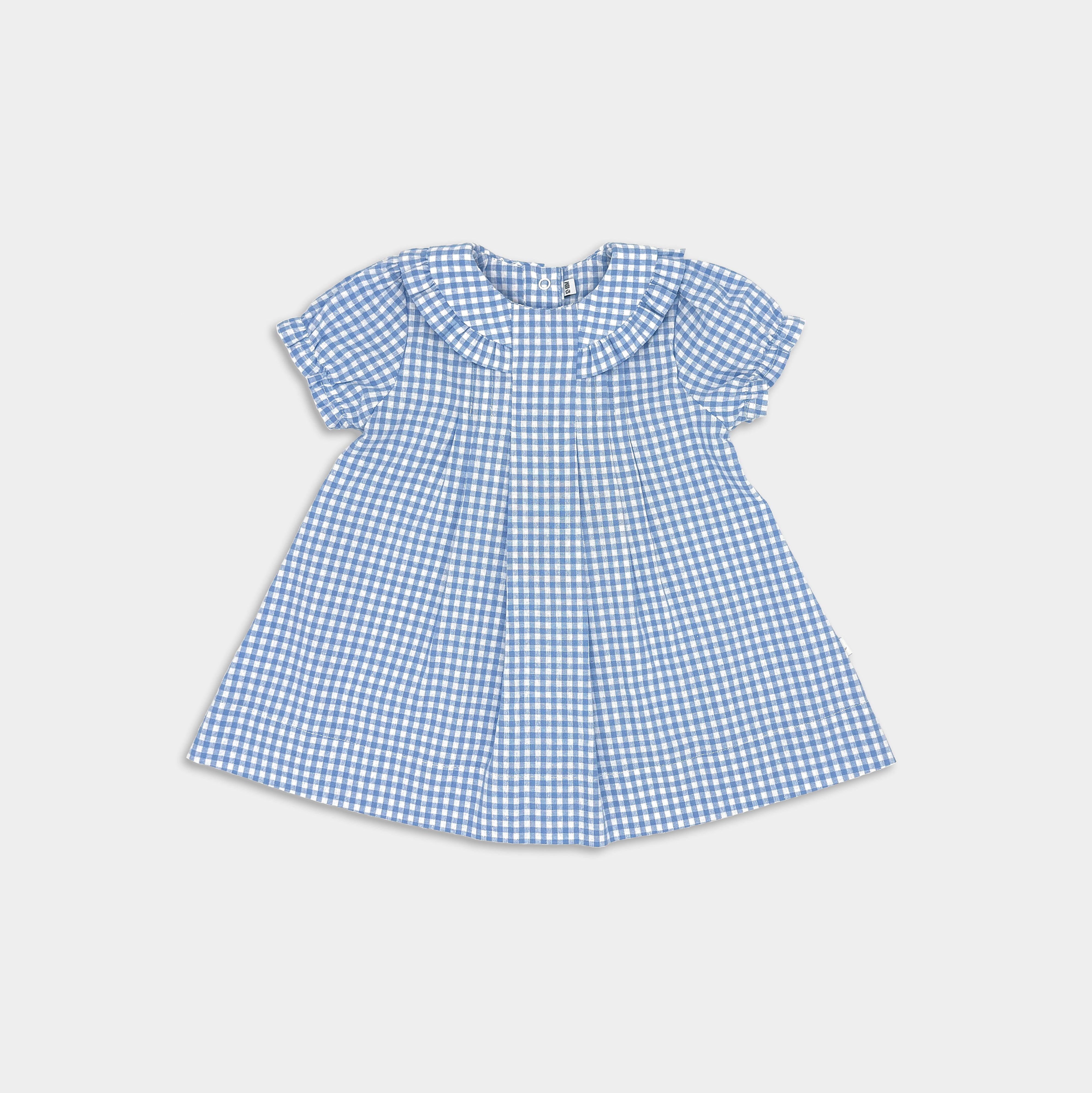 A sky blue gingham dress with a ruffled collar and sleeveless design, featuring front and back pleats and ring snaps at the waist.