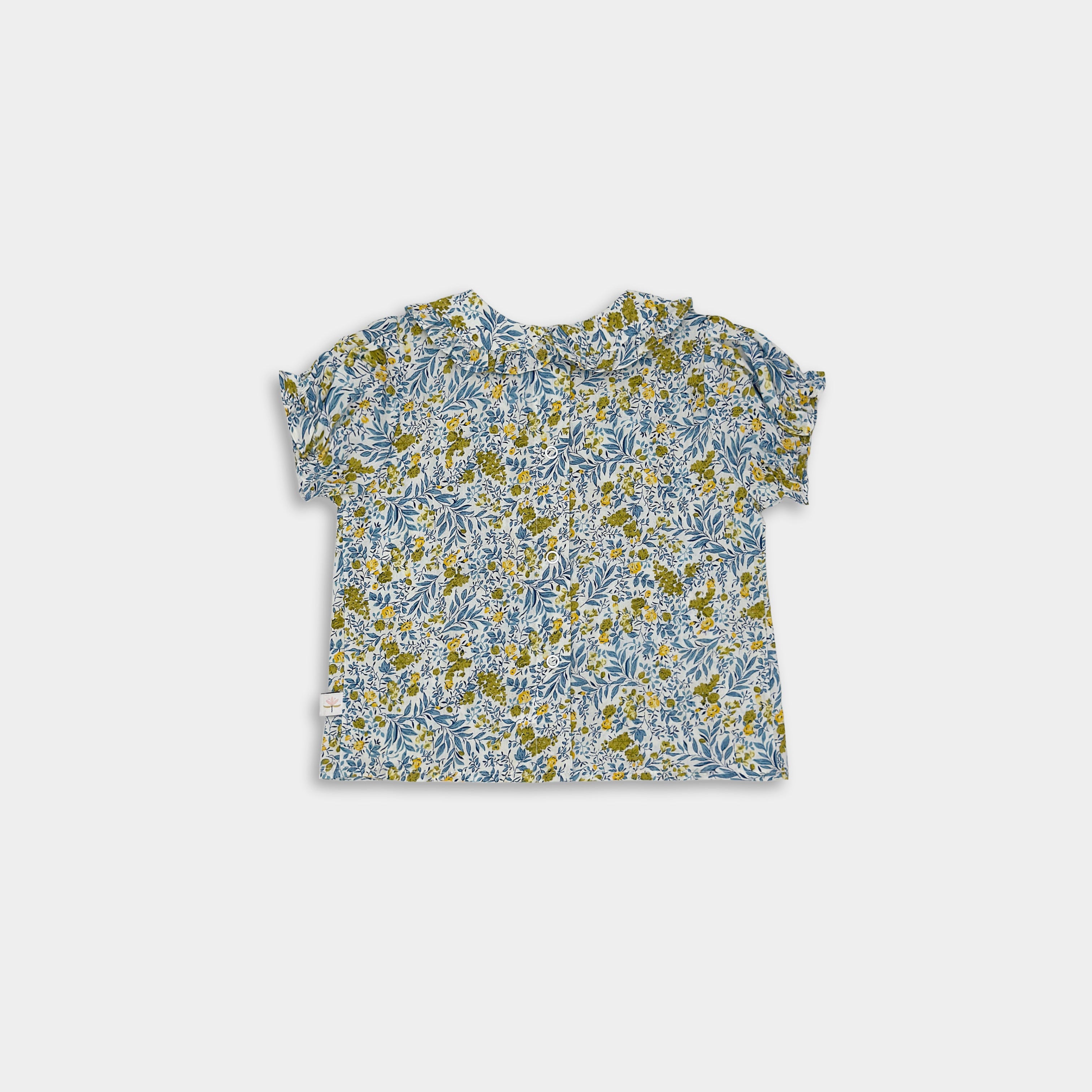 Back view of the Blue Floral blouse, showcasing the ruffled details and sustainable craftsmanship that make it ideal for little ones.
