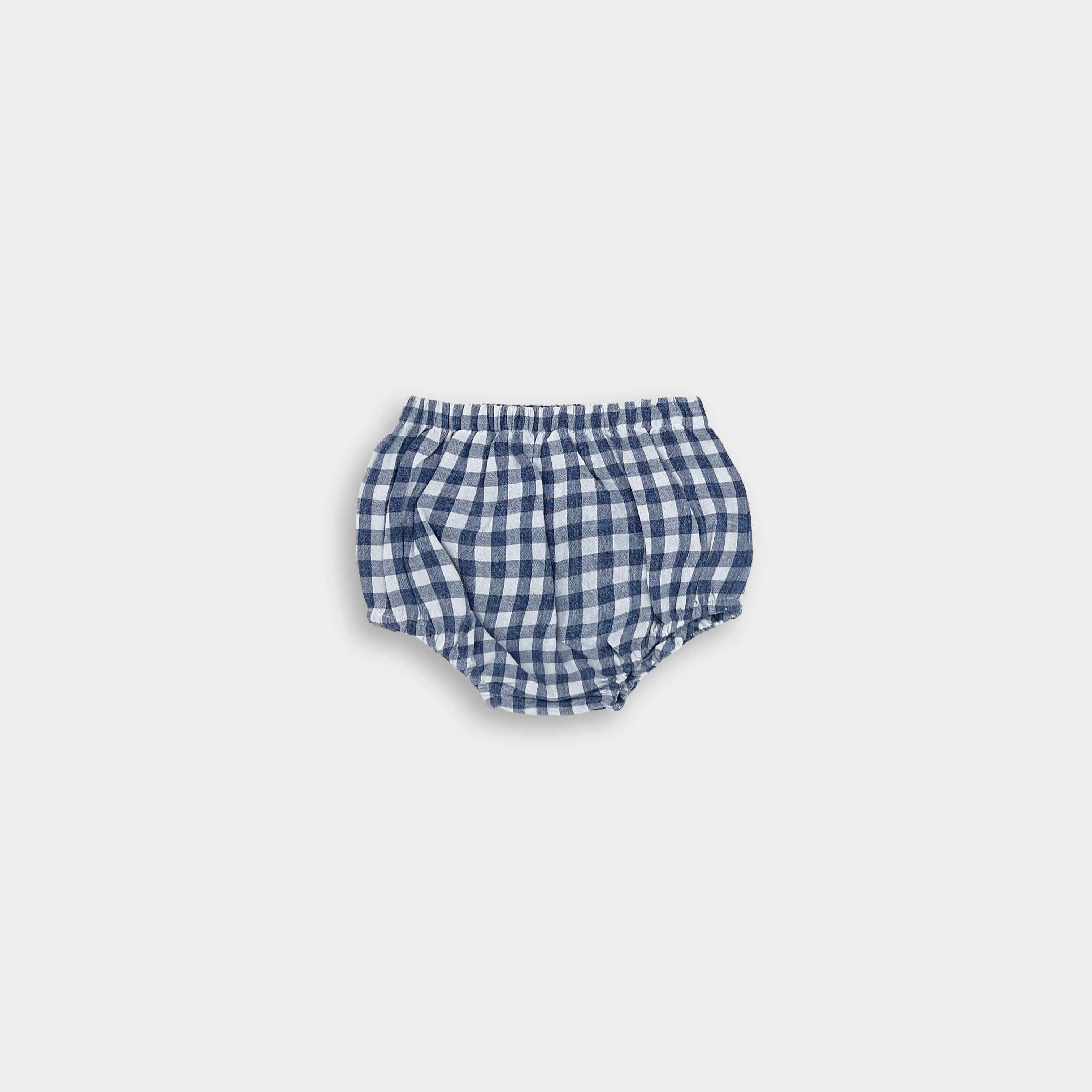 Sustainable blue gingham linen bloomers for babies made from a soft cotton-linen blend. Breathable and lightweight, these bloomers are a wardrobe essential and pair perfectly with our dresses for an eco-friendly look.