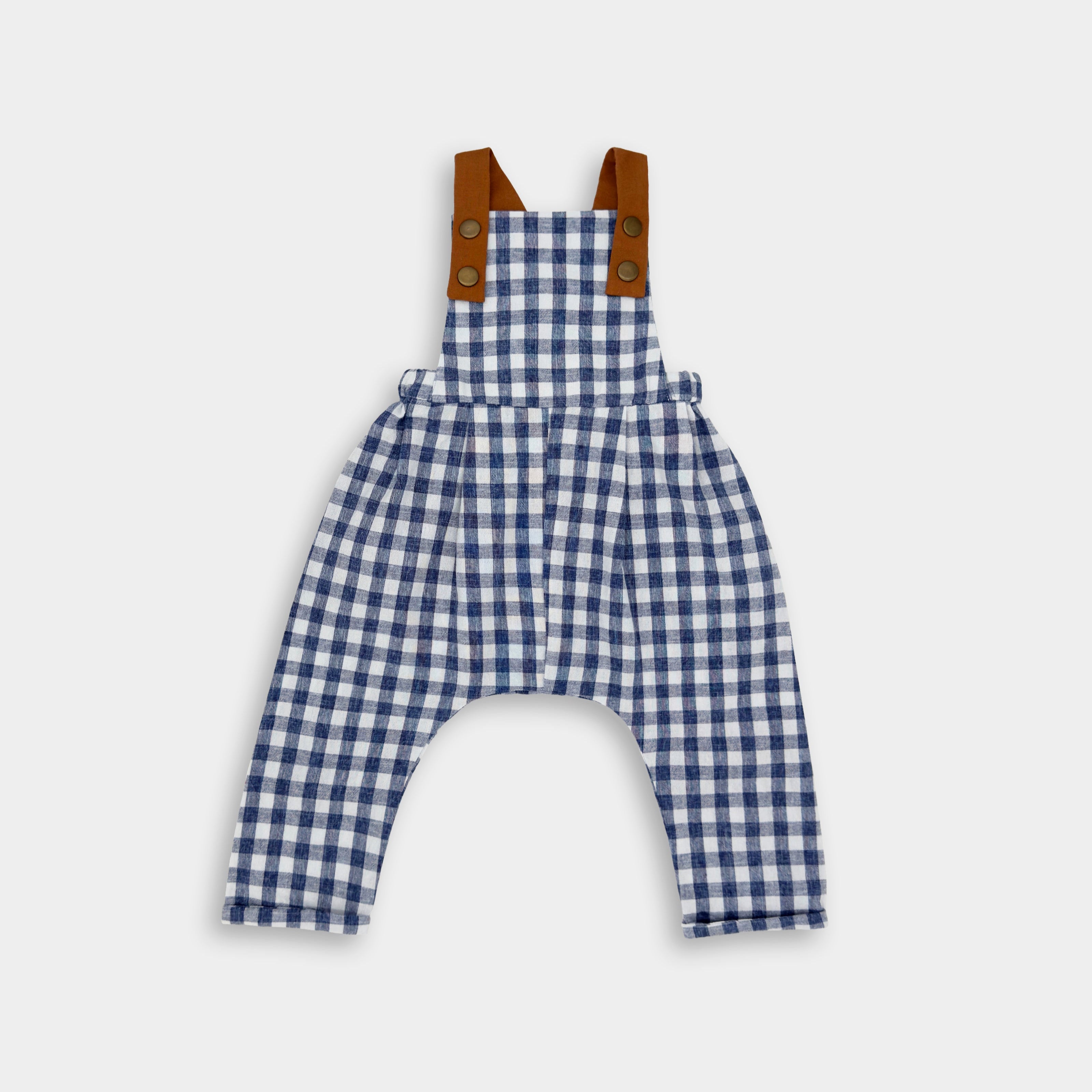 Blue Gingham Linen Long Overalls for kids, featuring gender-neutral design perfect for passing down, breathable fabric for comfort, stylish pleats for elegance, durable leather-looking straps, and adjustable straps for a perfect fit. Made by a sustainable brand focused on eco-friendly practices and materials, promoting responsible fashion for children.