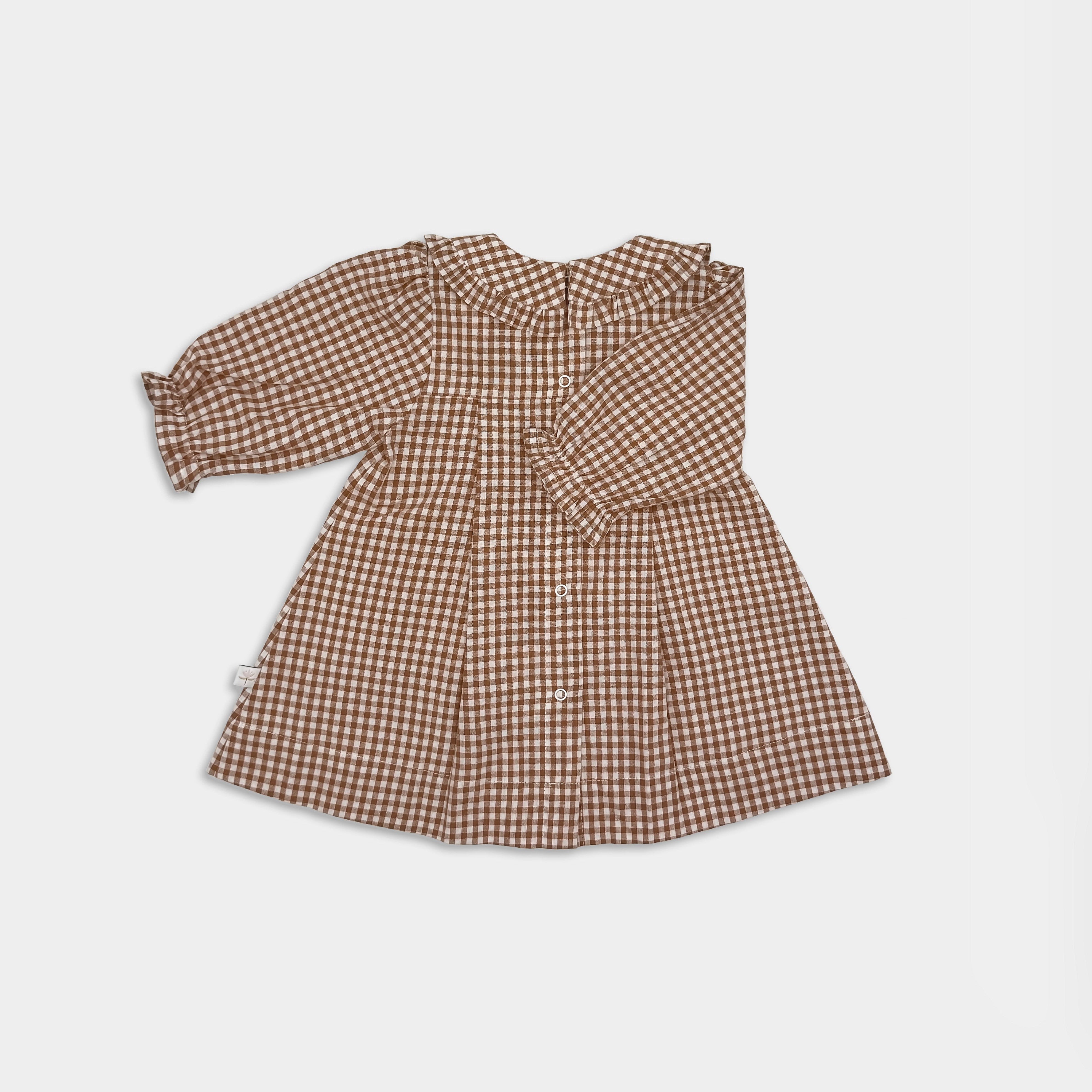 Back view of brown checkered dress on a light grey background