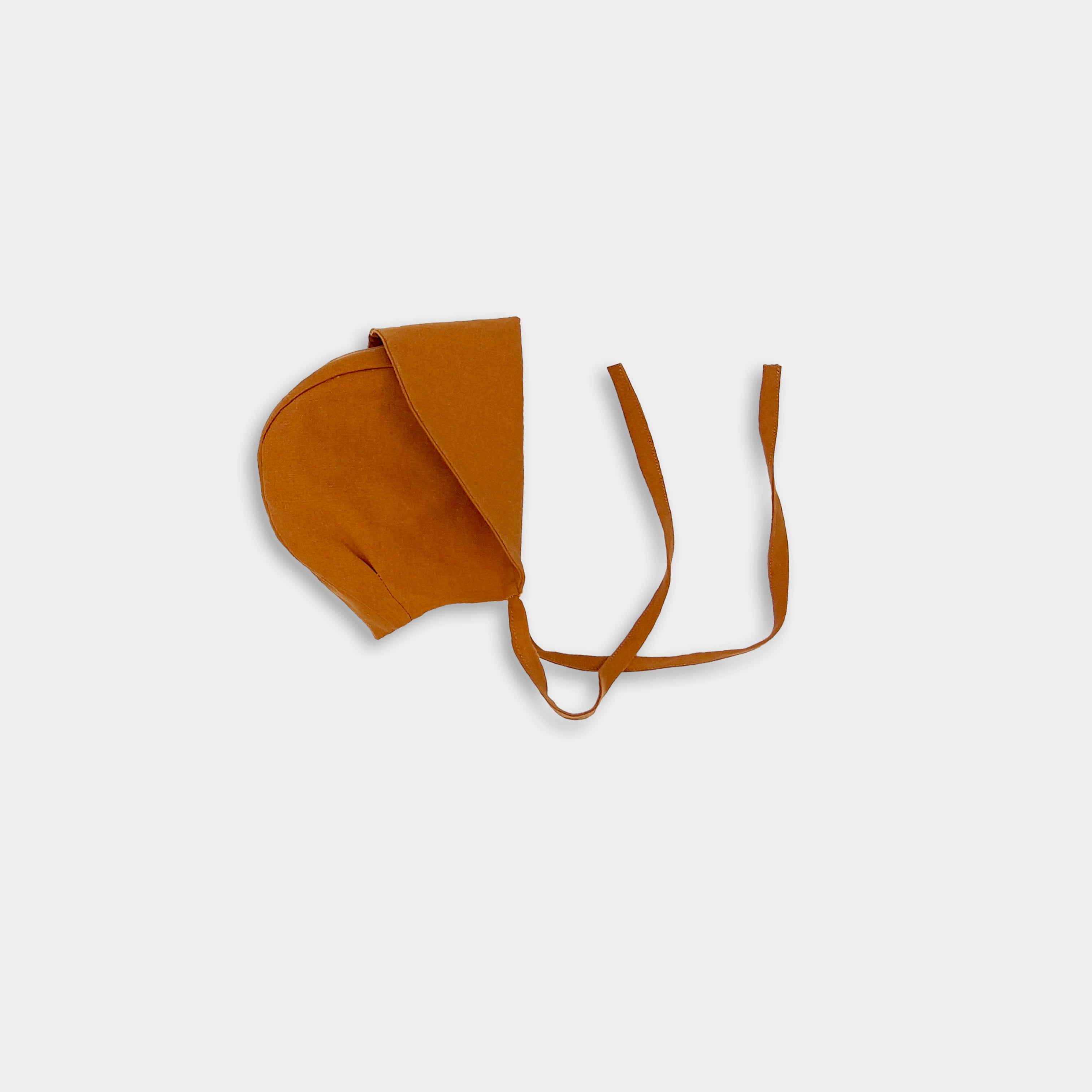 Photo of the Burnt Orange Sunbonnet with brim folded - This image showcases the sunbonnet with the brim folded up, highlighting its elegant design and versatility as a stylish accessory.
