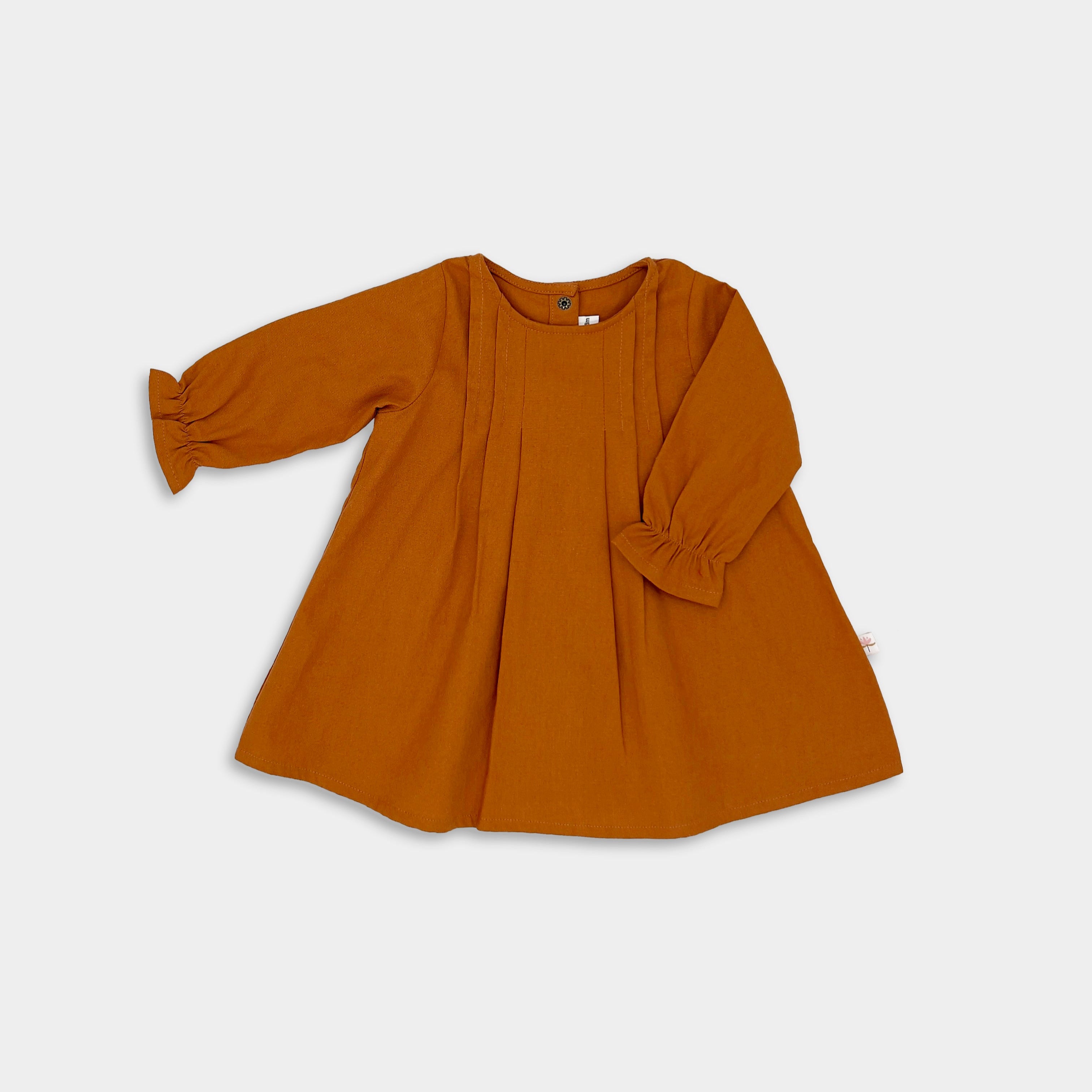 Photo of the Burnt Orange Linen Dress alone - This image showcases the elegant long sleeve design of the dress, highlighting its earthy color and overall silhouette.
