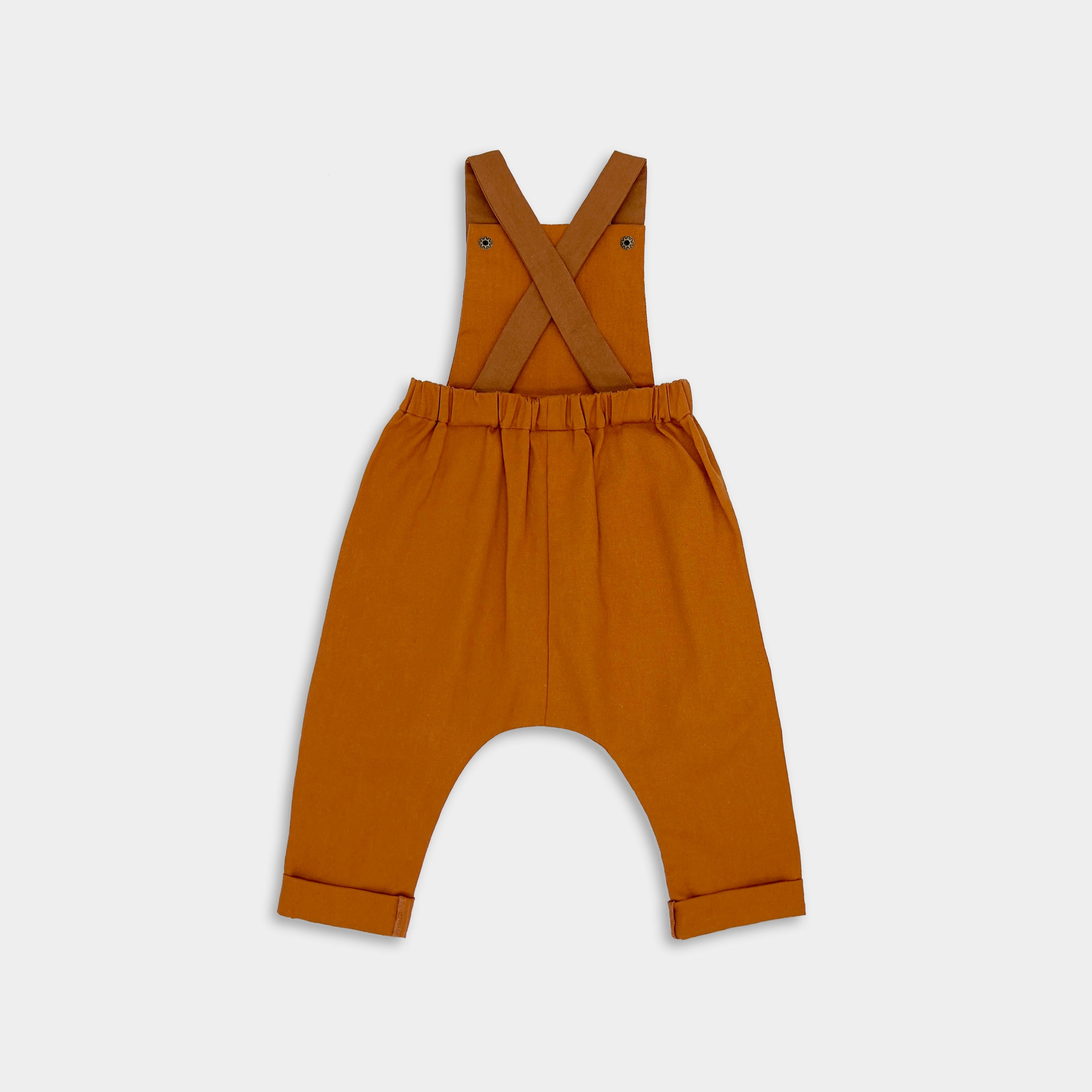 Close-up back view of Burnt Orange Linen Overalls - This image highlights the rich color and quality fabric of the overalls, showcasing their timeless and photogenic appeal