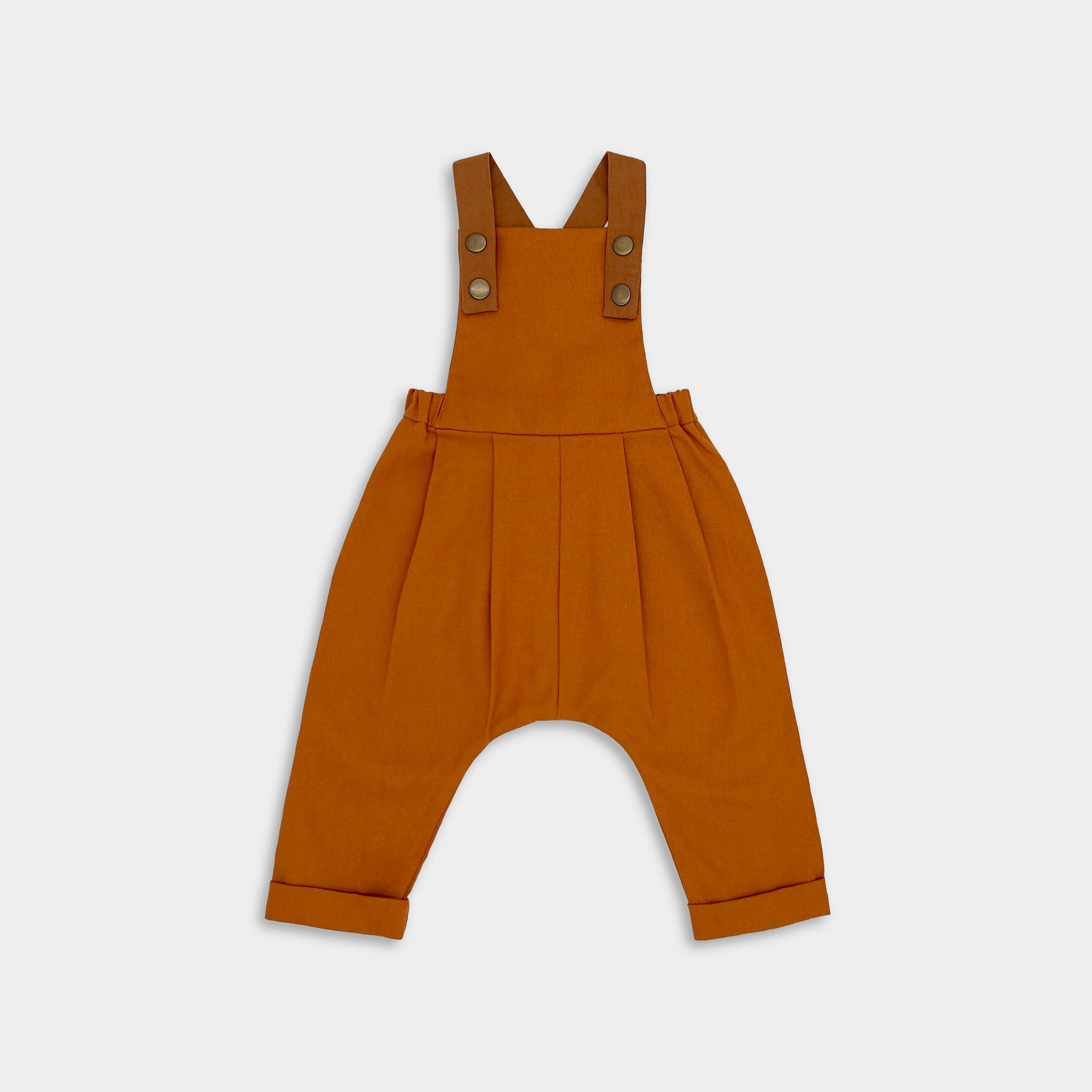 Close-up of Burnt Orange Linen Overalls - This image highlights the rich color and quality fabric of the overalls, showcasing their timeless and photogenic appeal