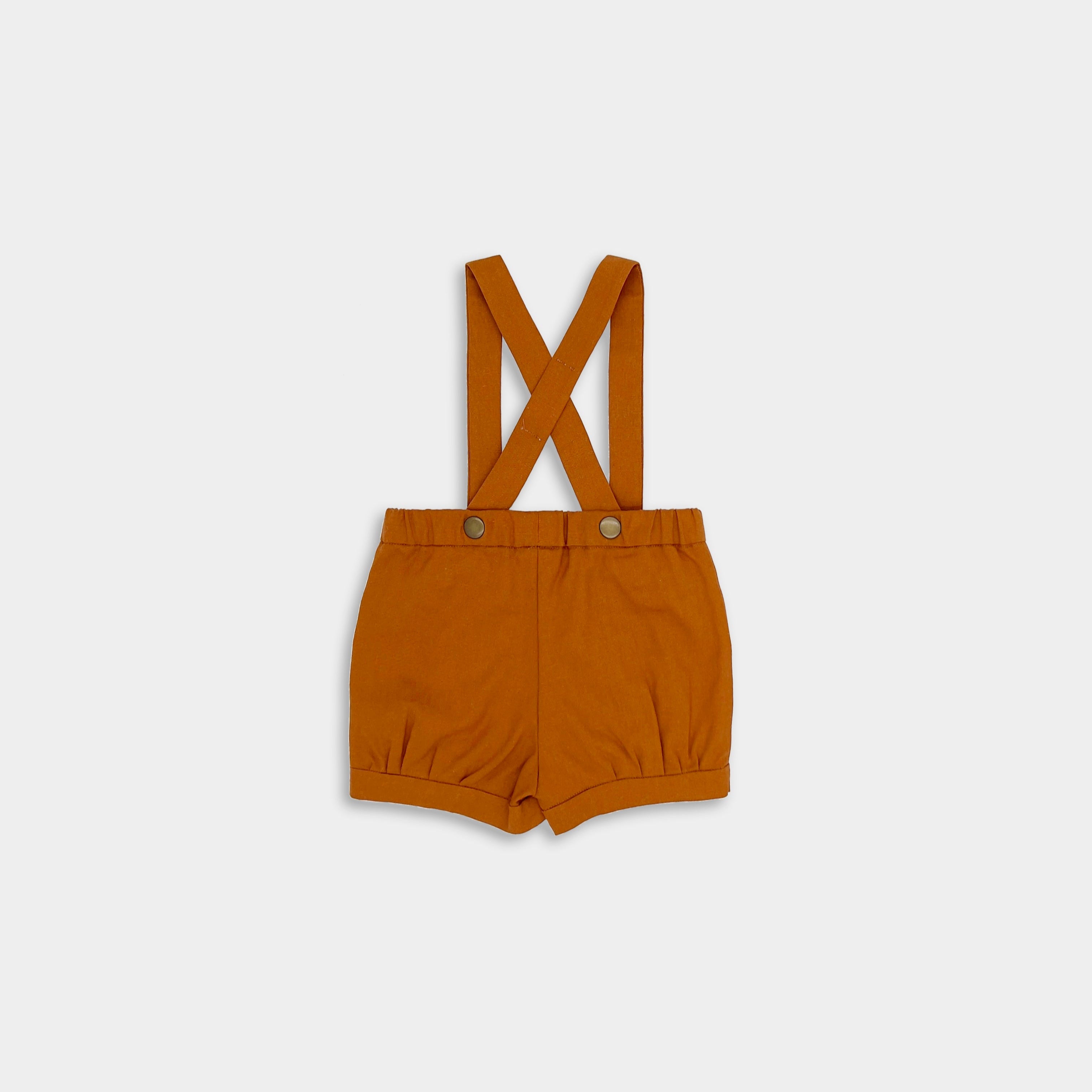 Photo of the Burnt Orange Suspender Shorts back view - This image captures the back of the shorts, emphasizing the convenient label positioning and overall fit of the garment.