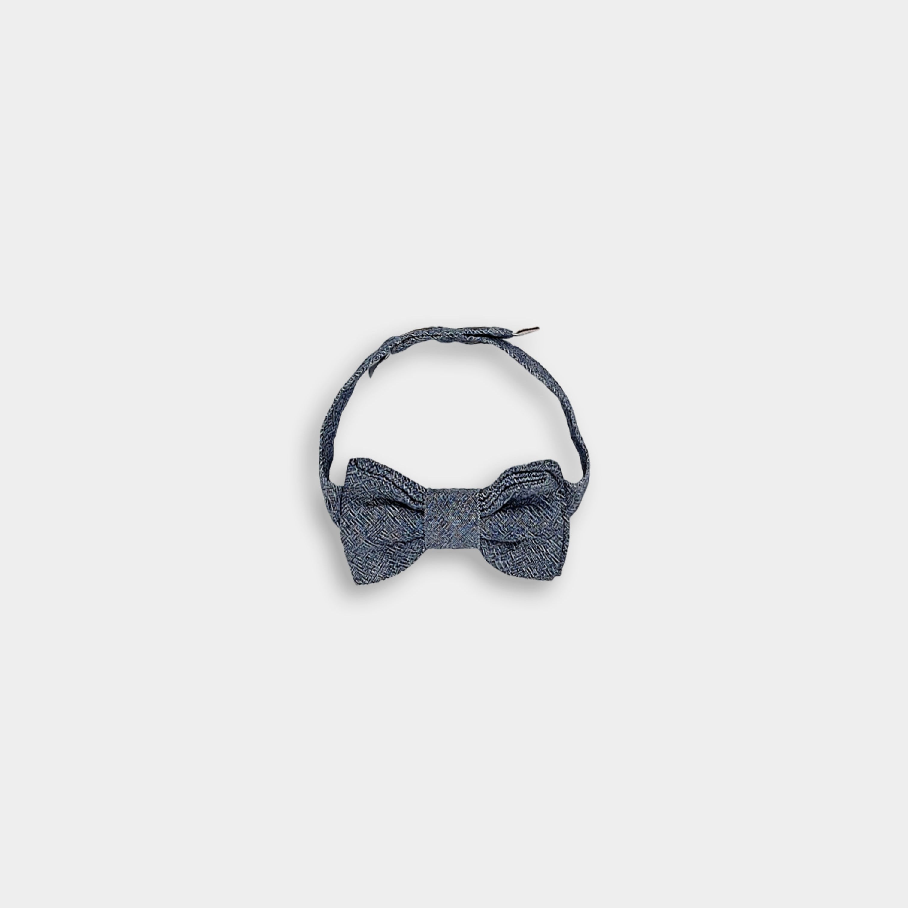 Bow Tie with Strap: The Chambray Blue bow tie is displayed alongside its adjustable strap, demonstrating its ease of use and adaptability for different styles, suitable for layering over shirts or wearing on its own.