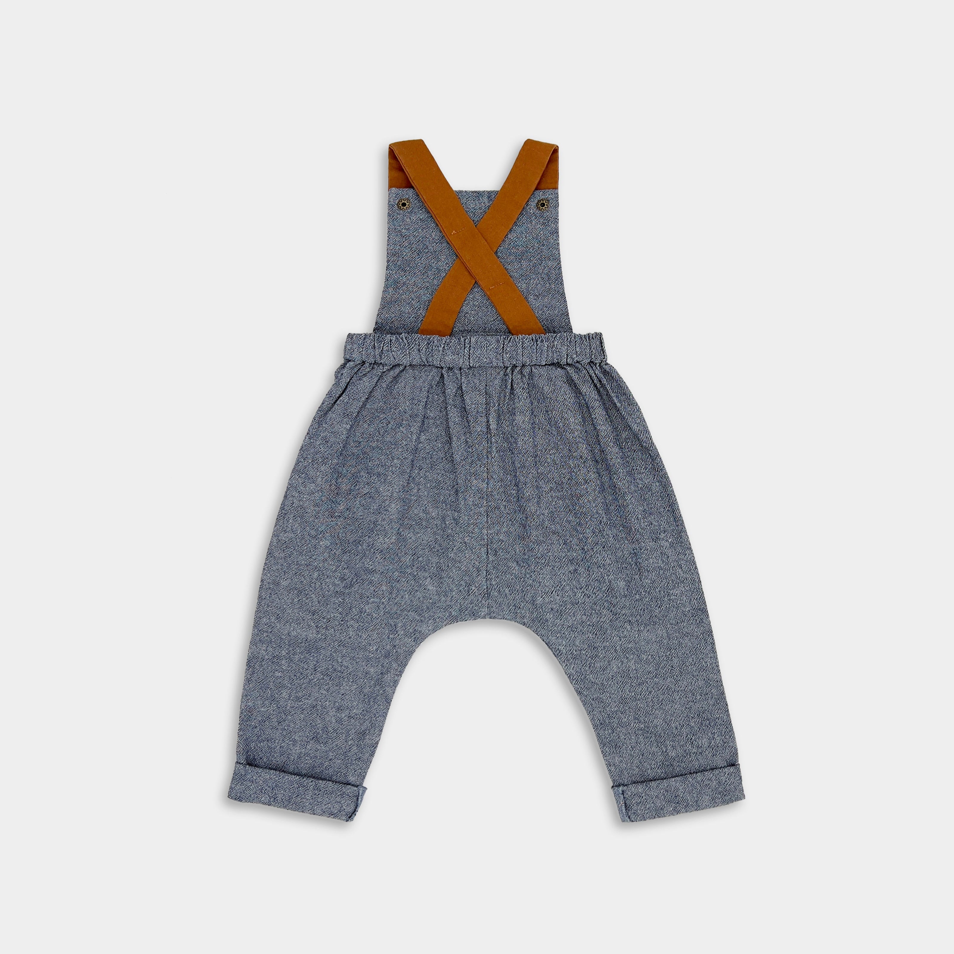 Back View of Chambray Blue Linen Long Overalls Alone: A standalone back view of the Chambray Blue Long Overalls, emphasizing the quality craftsmanship and thoughtful design features suitable for passing down through families.