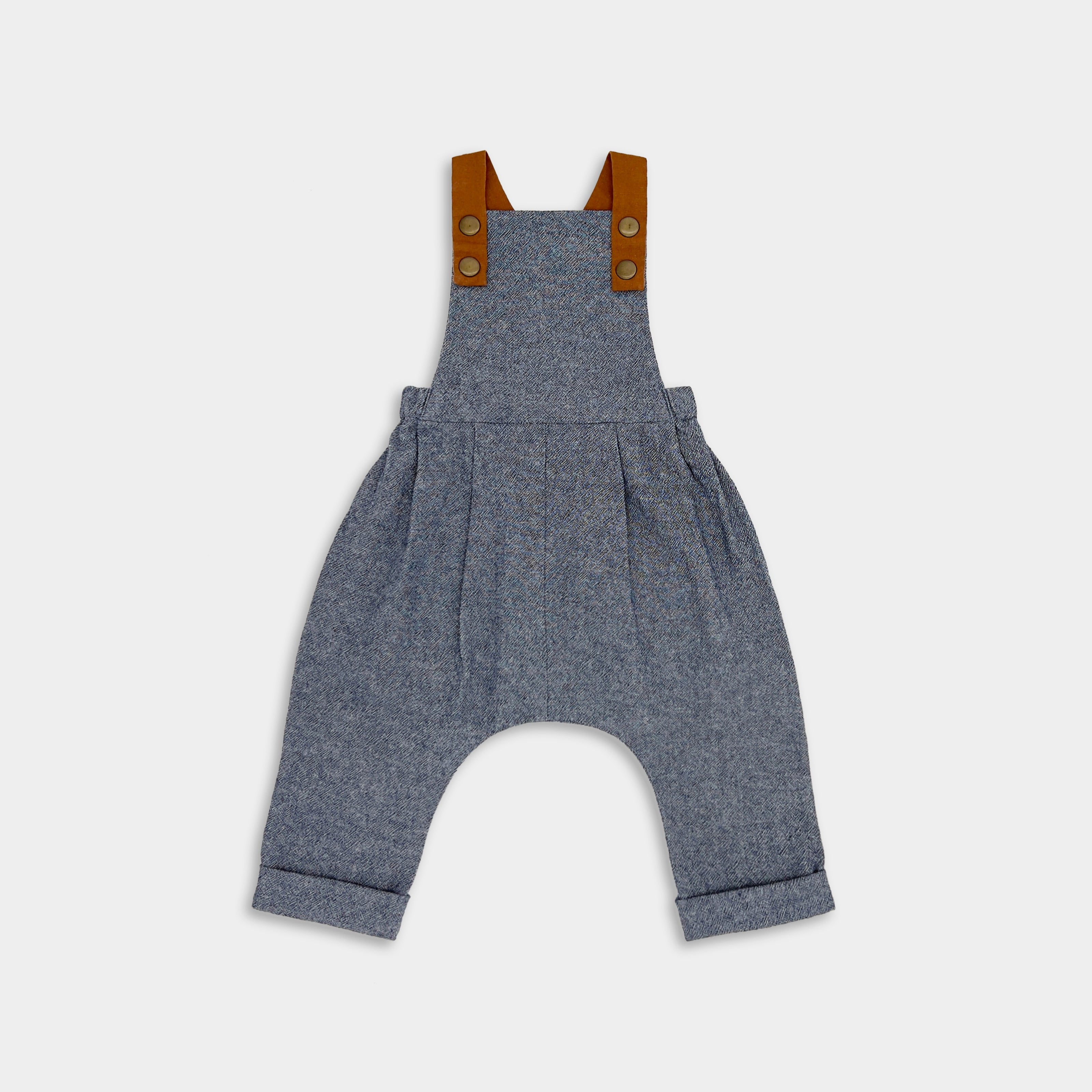 Product Front View of Chambray Blue Long Overalls: A front view of the Chambray Blue Linen Long Overalls, highlighting their classic denim look, stylish pleats, and leather-looking straps that enhance both durability and visual appeal.