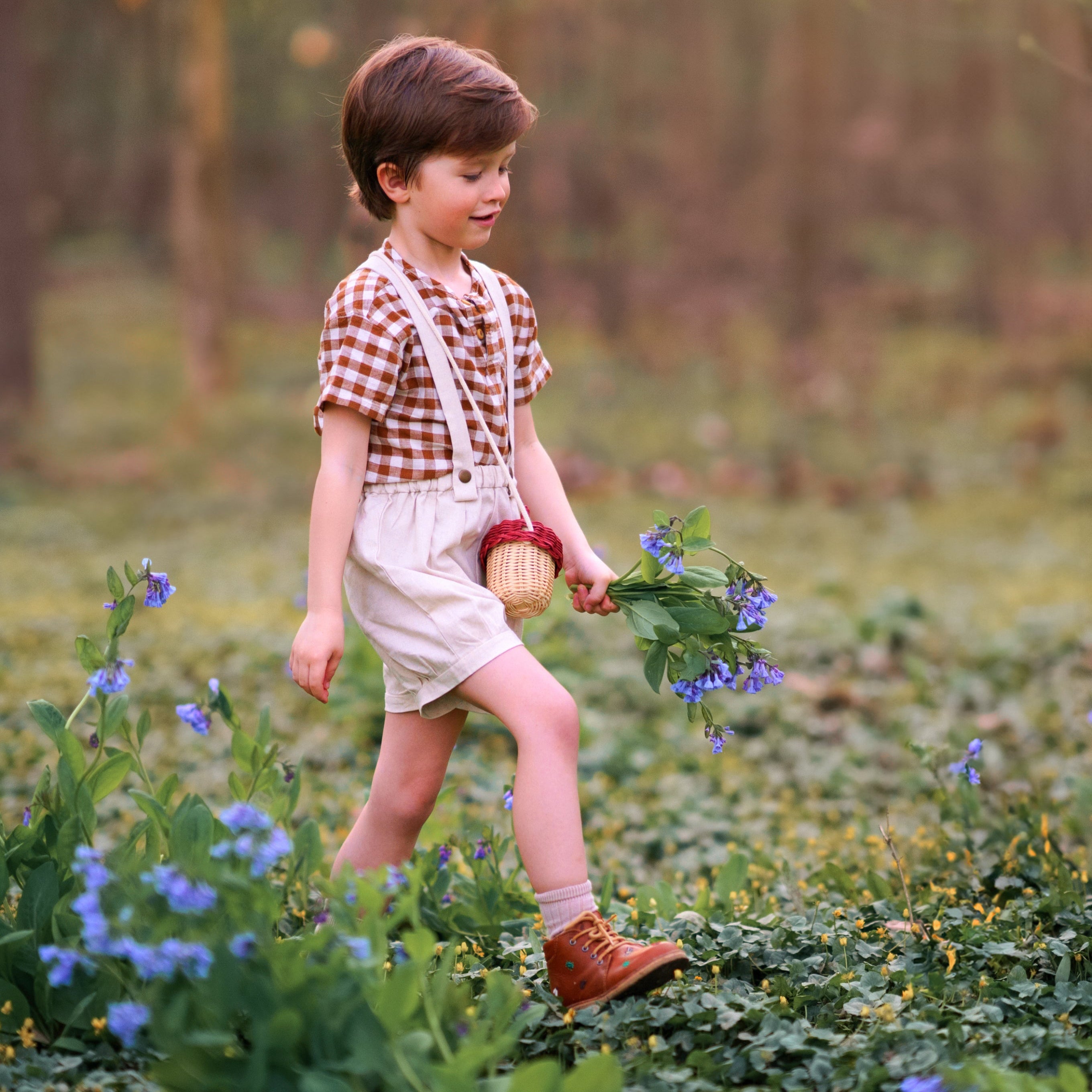 Child walking through a field of flowers holding a basket