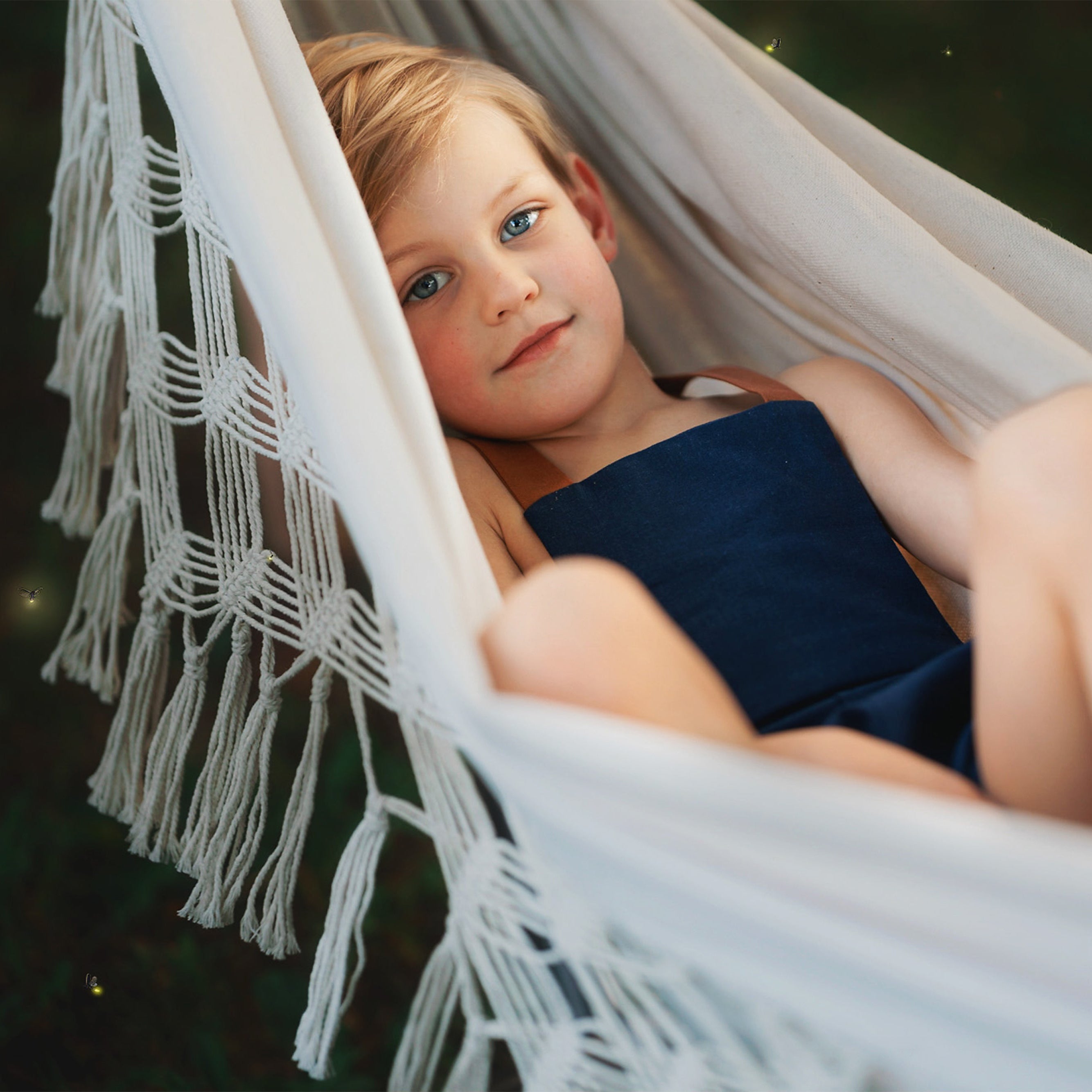 Boy in a hammock wearing Navy overalls