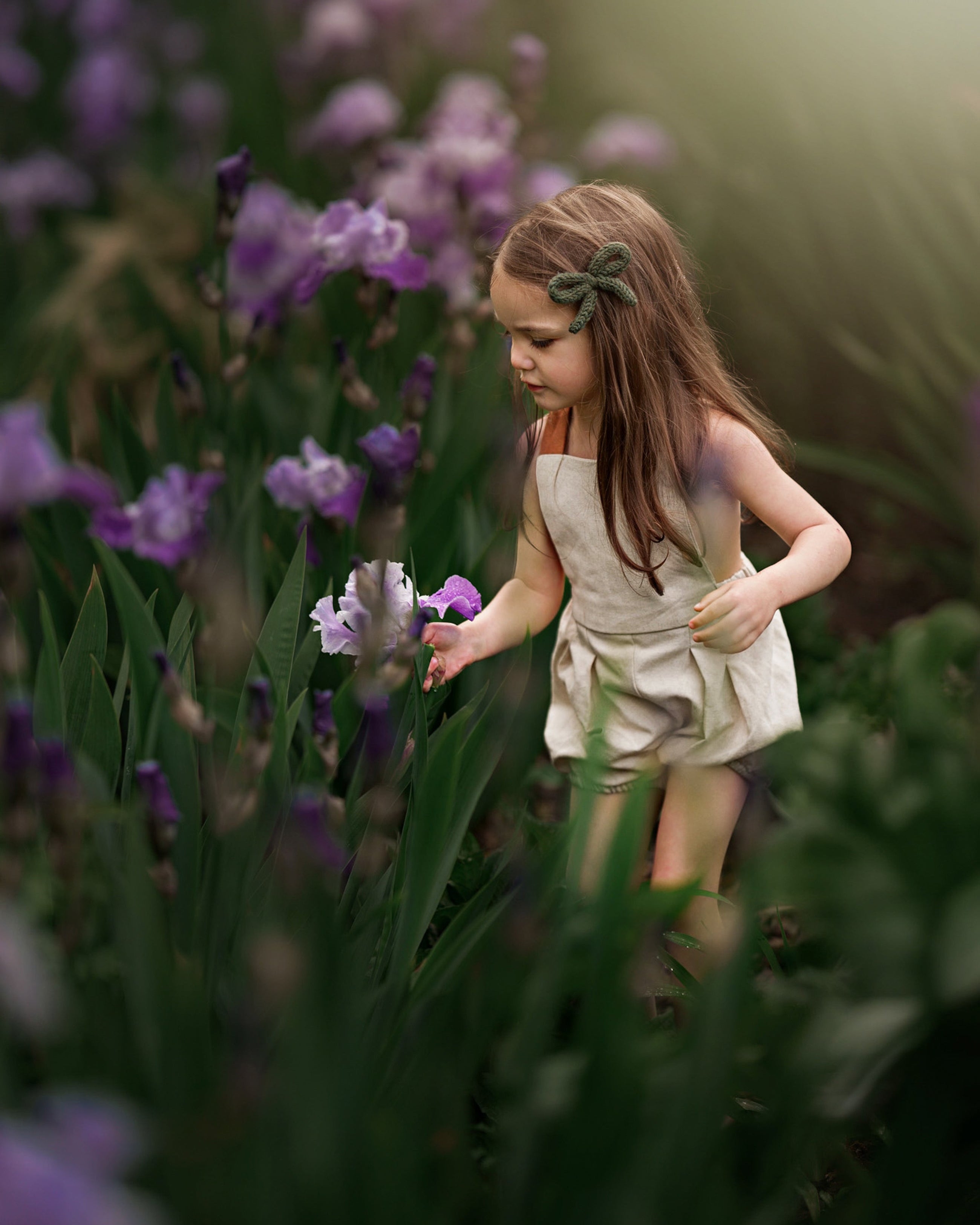 Young girl in a natural setting with purple flowers