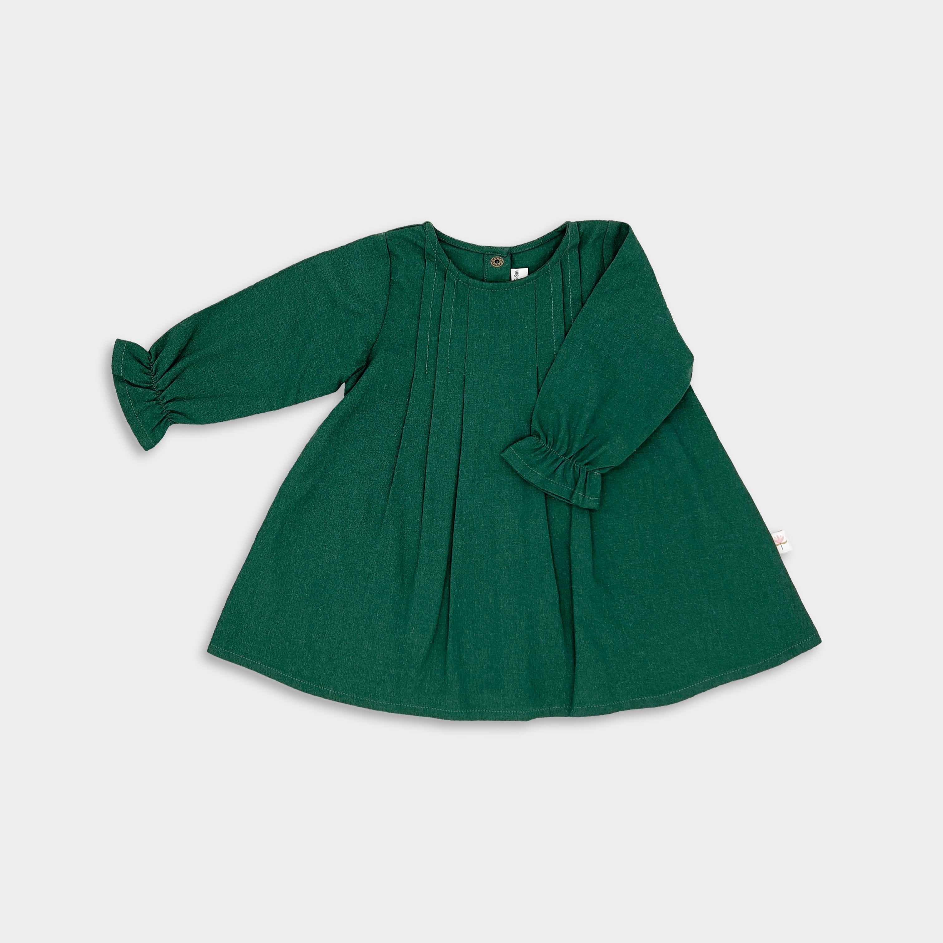 Front view of the evergreen linen dress, showcasing the vibrant hue and chic minimalist design with pin-tucked details that add sophistication.