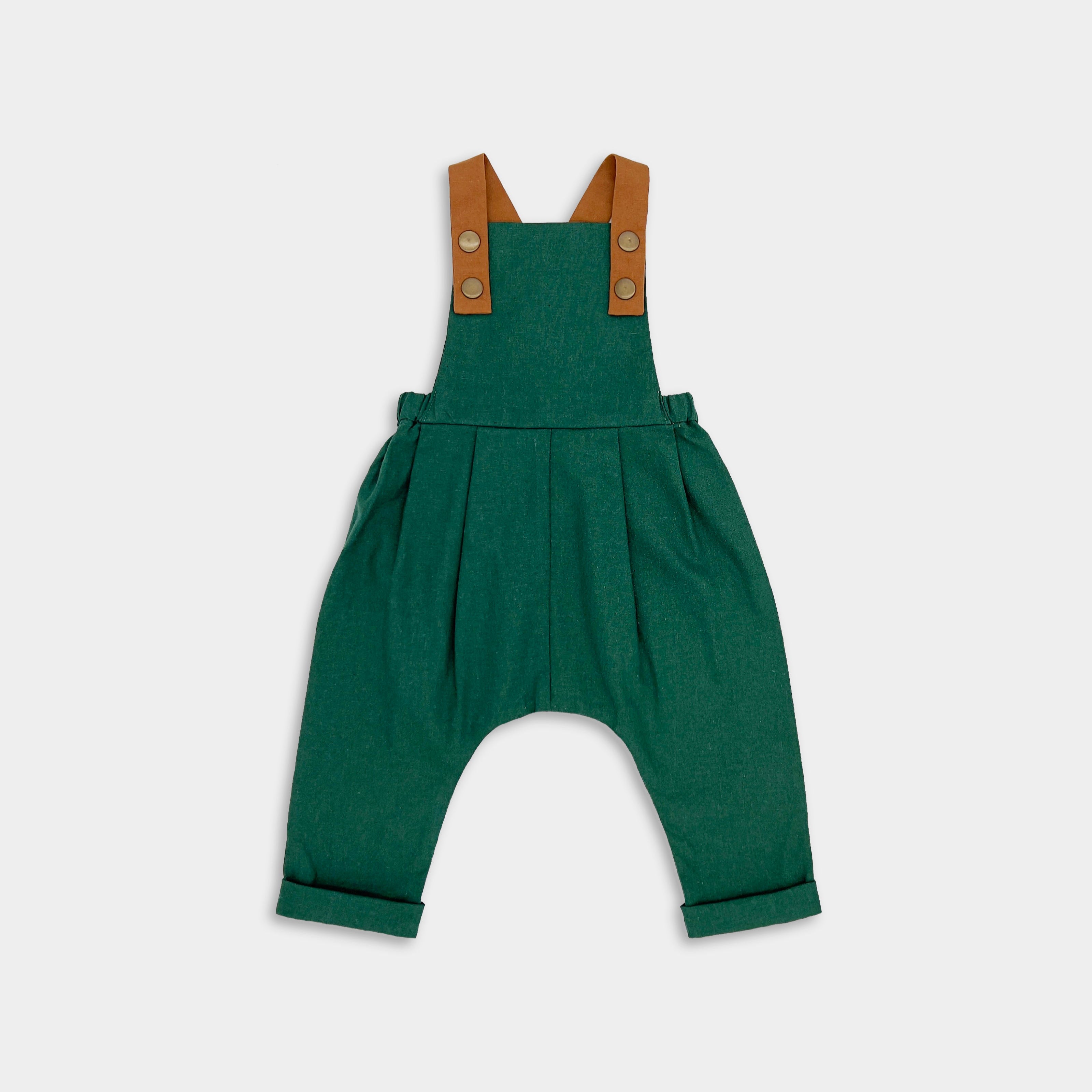 Front view of evergreen linen long overalls, showcasing the stylish pleats and leather-looking straps that enhance both durability and visual appeal.