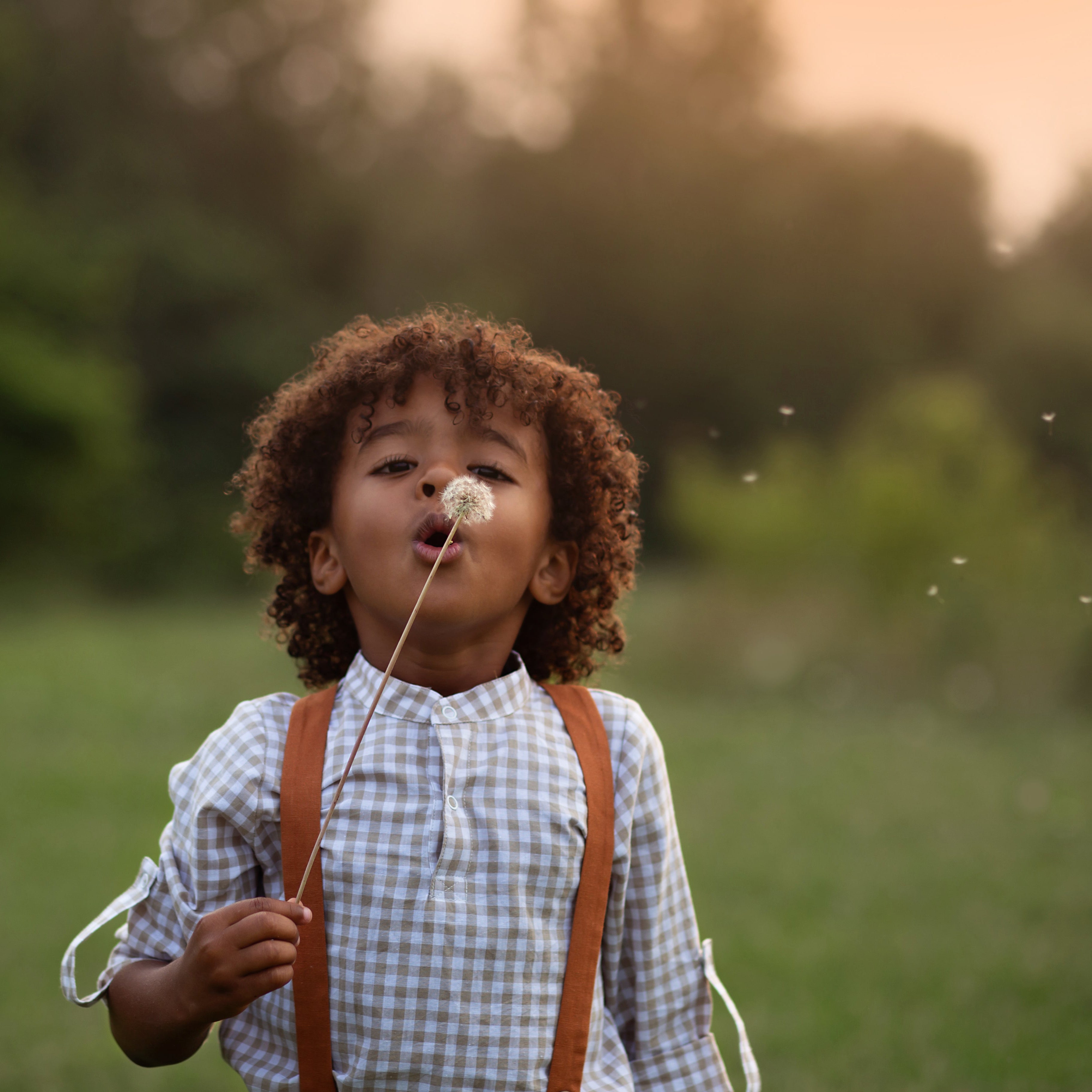 Beige Gingham Henley Shirt worn by 5-year-old boy in size 5Y, featuring a classic Henley placket and 3/4 cuffed sleeves that can be unrolled for layering. Paired with burnt orange linen suspender shorts for a stylish, versatile outfit.