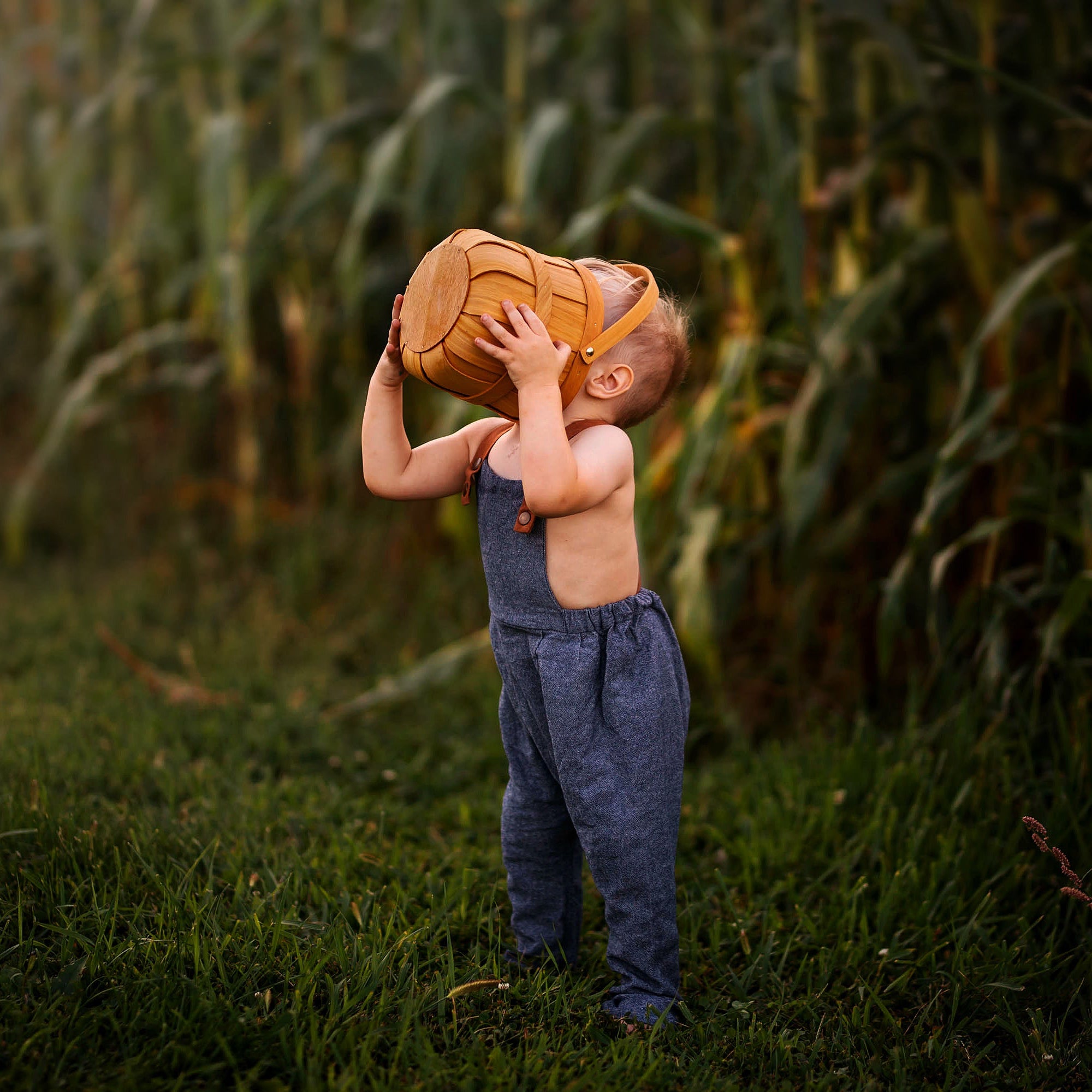 Goofy Pose of Model in Chambray Blue Linen Long Overalls: The model is being silly in the Chambray Blue Long Overalls, illustrating the playful nature of the outfit while emphasizing its comfort and ease of movement.