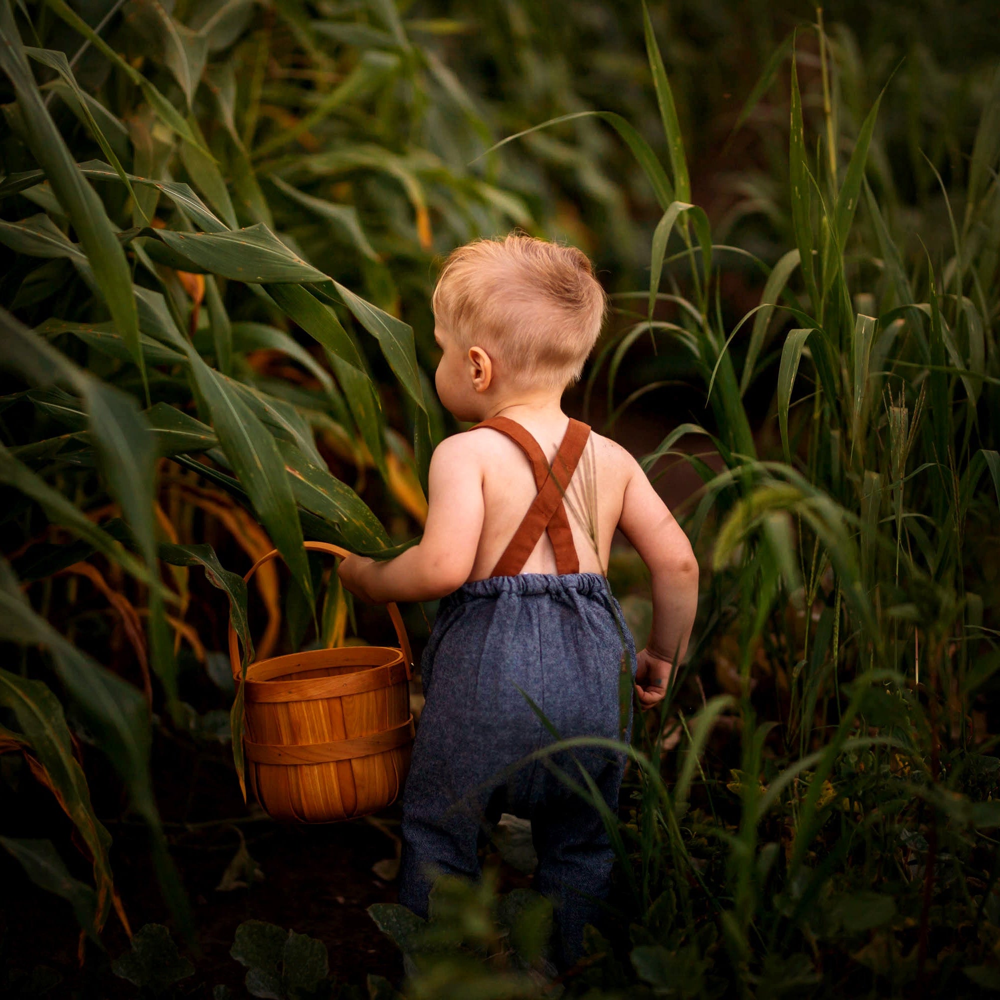 Back View of Model in Chambray Blue Long Overalls: A back view of the model wearing the Chambray Blue Linen Long Overalls, highlighting the adjustable straps and breathable fabric, designed for comfort and functionality.