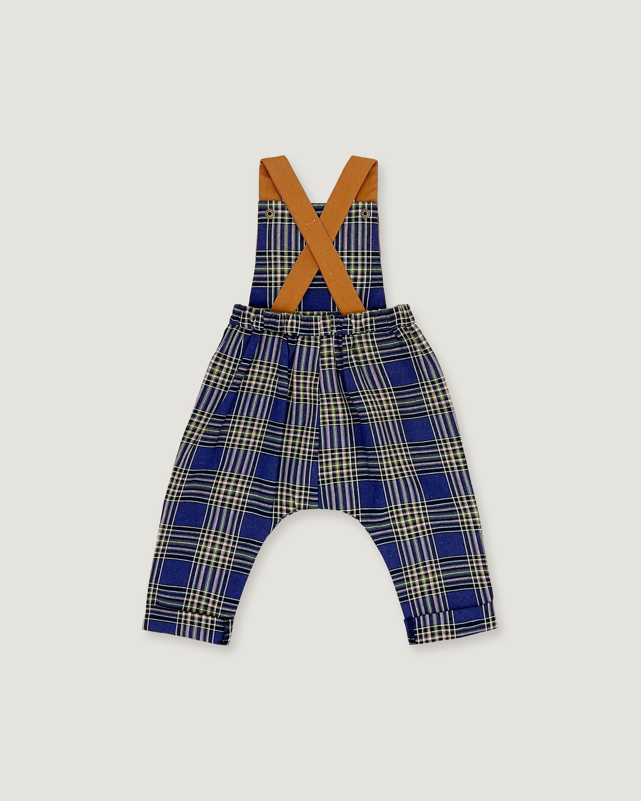 A baby romper with suspenders featuring a blue, beige, and white plaid pattern, with contrasting tan shoulder straps, shown on a light gray background.