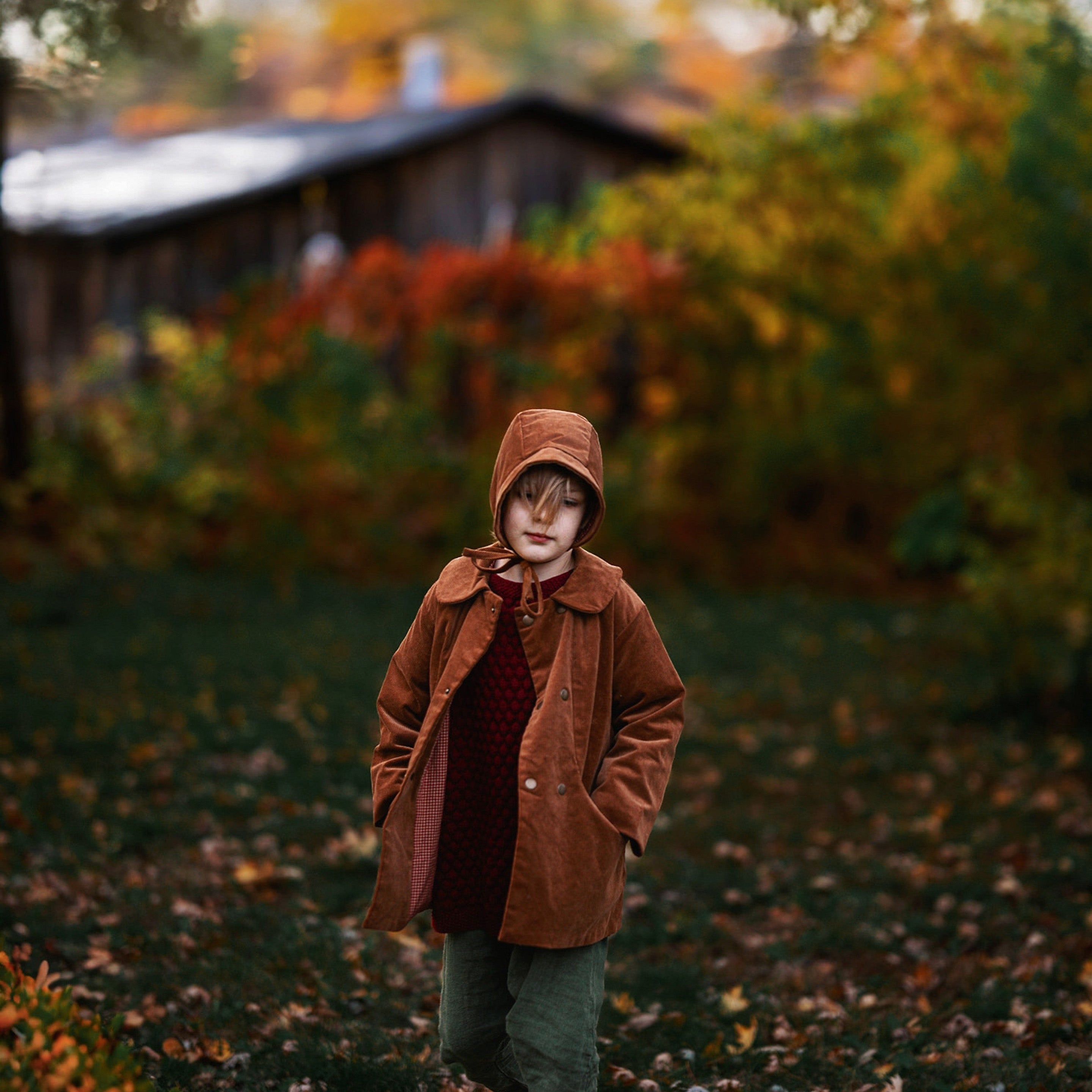 Ezra, a 5-year-old boy model, is captured mid-stride in the Camel coat and matching Camel Corduroy Bonnet, embodying playful energy and style, perfect for active children.