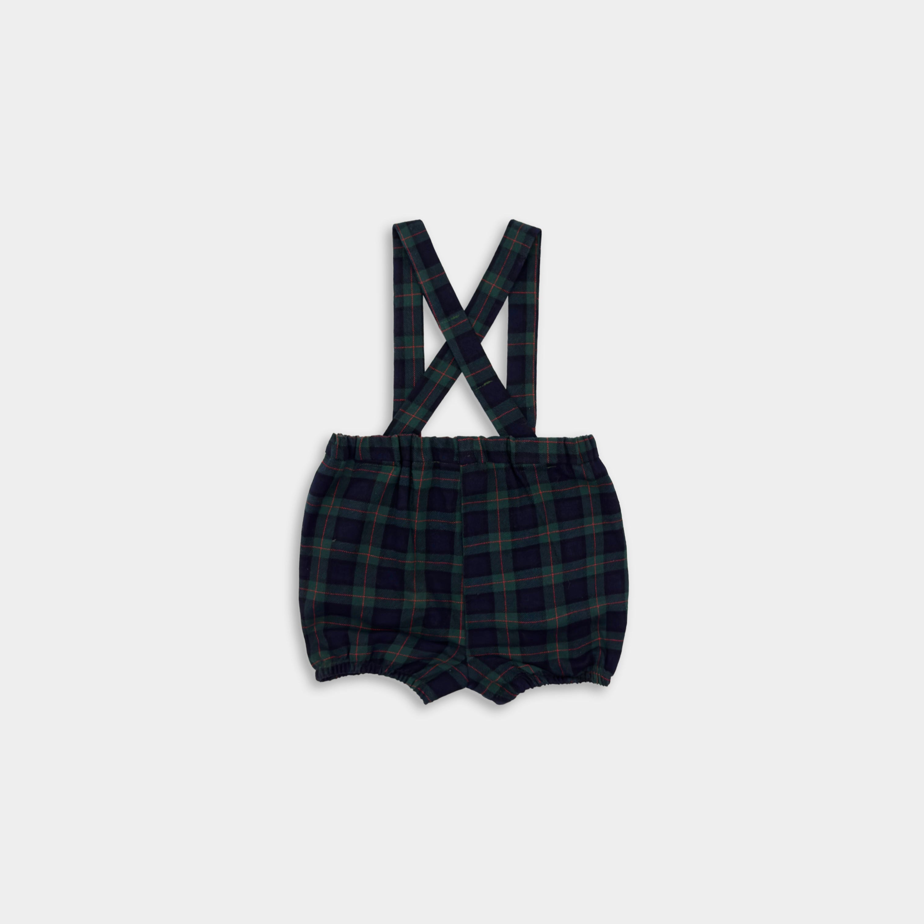 Plaid baby romper with suspenders on a white background