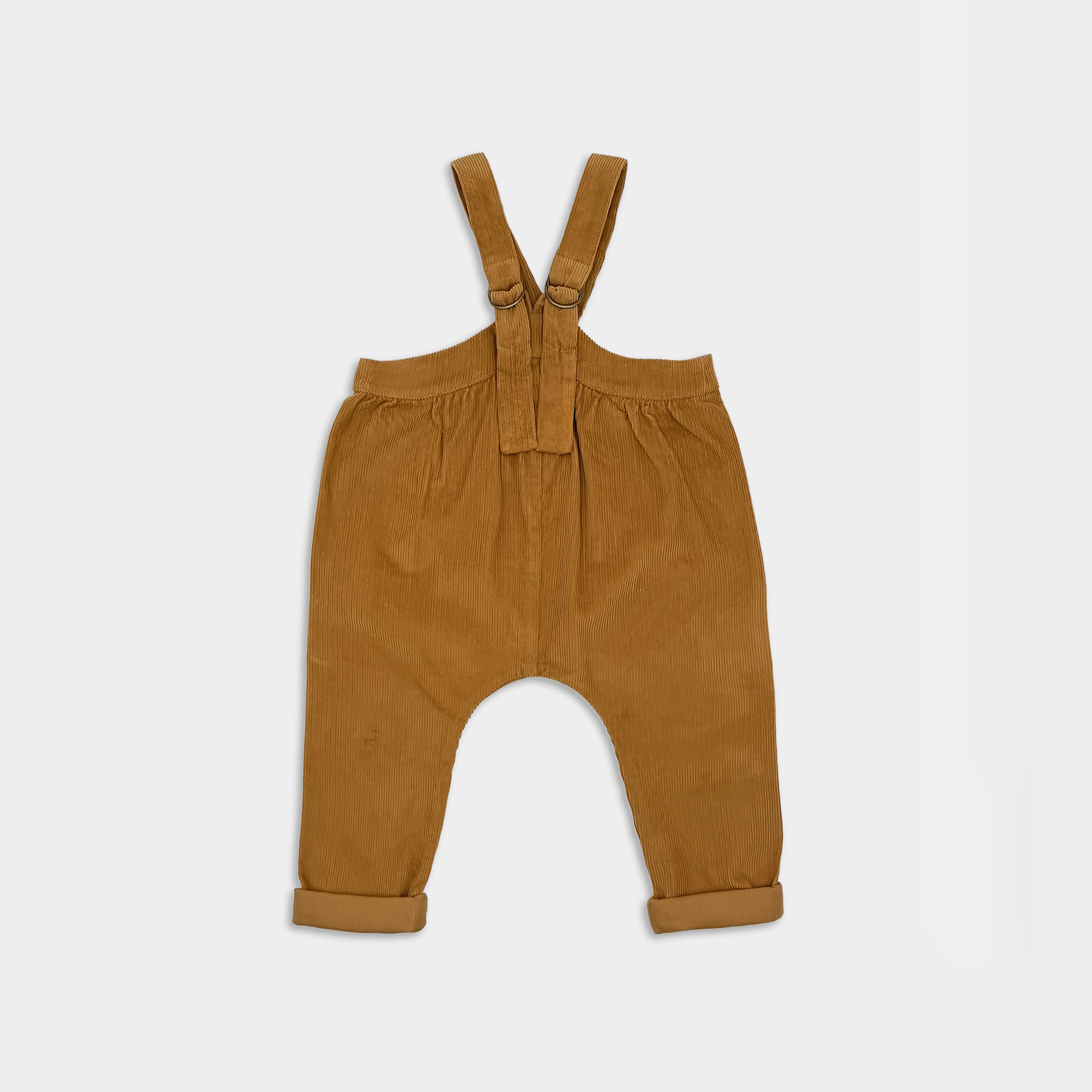 Mustard corduroy baby overalls on a white background