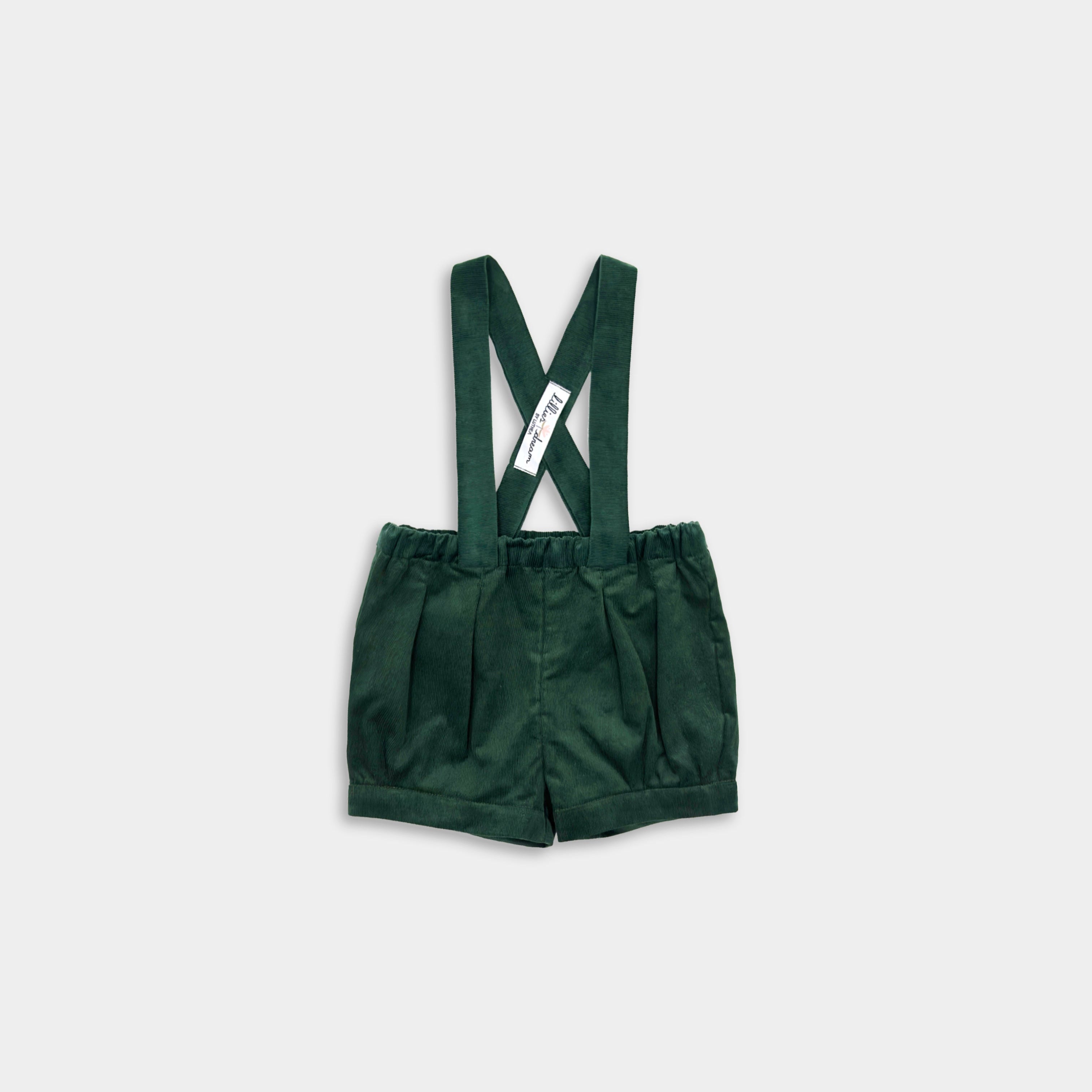 Evergreen micro corduroy suspender shorts with adjustable straps, pleats, and cuffs, featuring a conveniently positioned label.