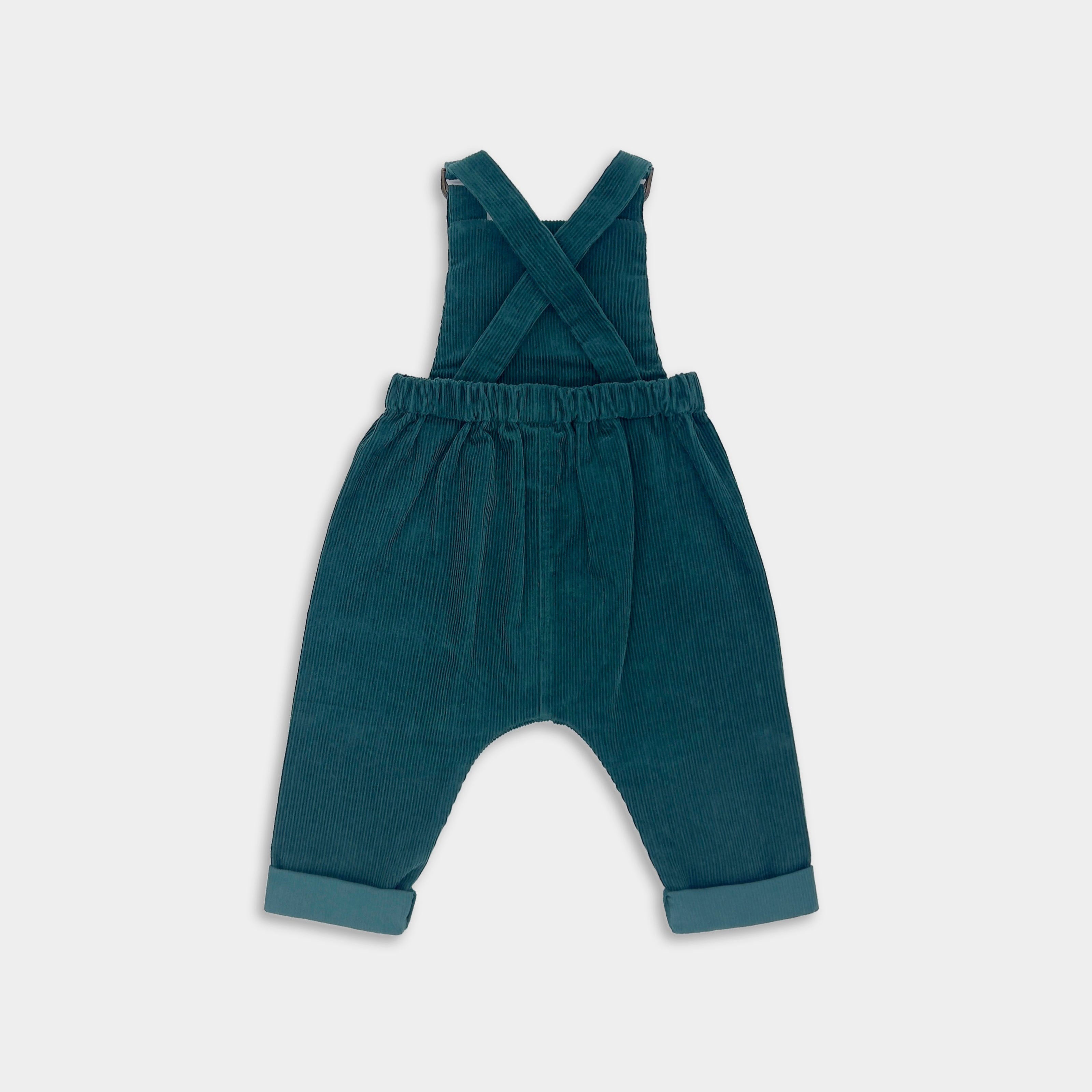 Green corduroy overalls on a white background