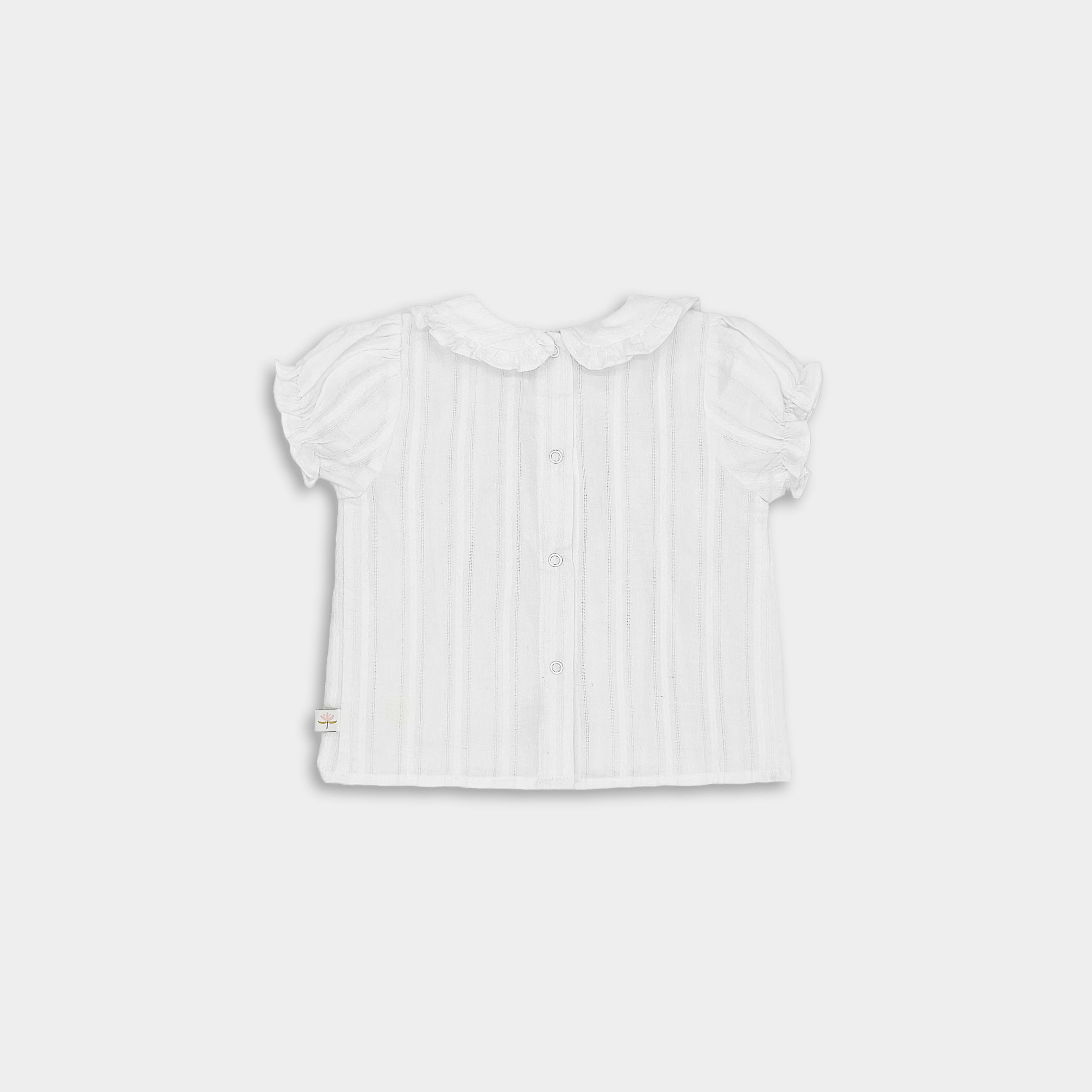 Black view of white blouse with frilly details for little girls