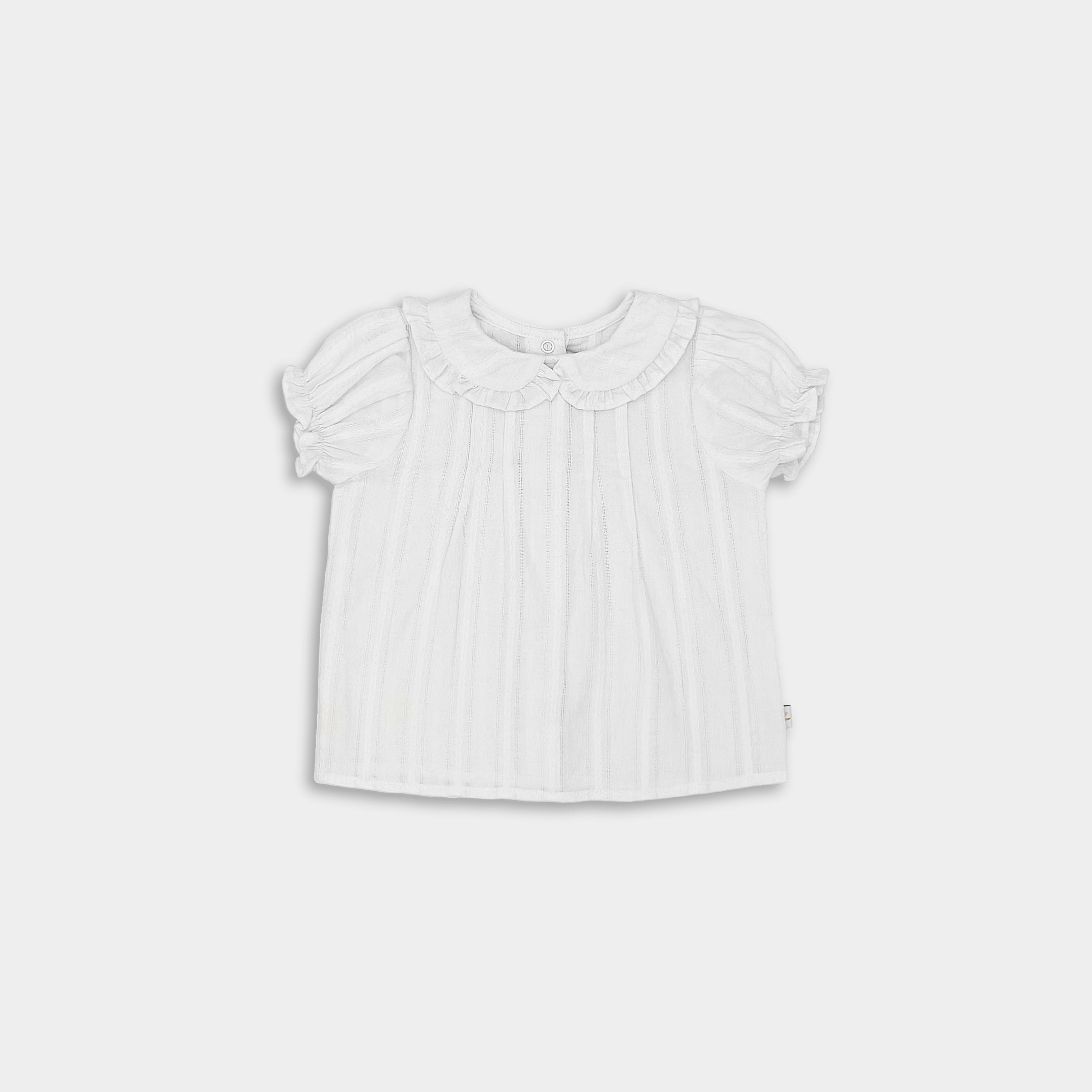 A white short-sleeved blouse with a ruffled Peter Pan collar and pin tucks at the front, displayed against a plain background.