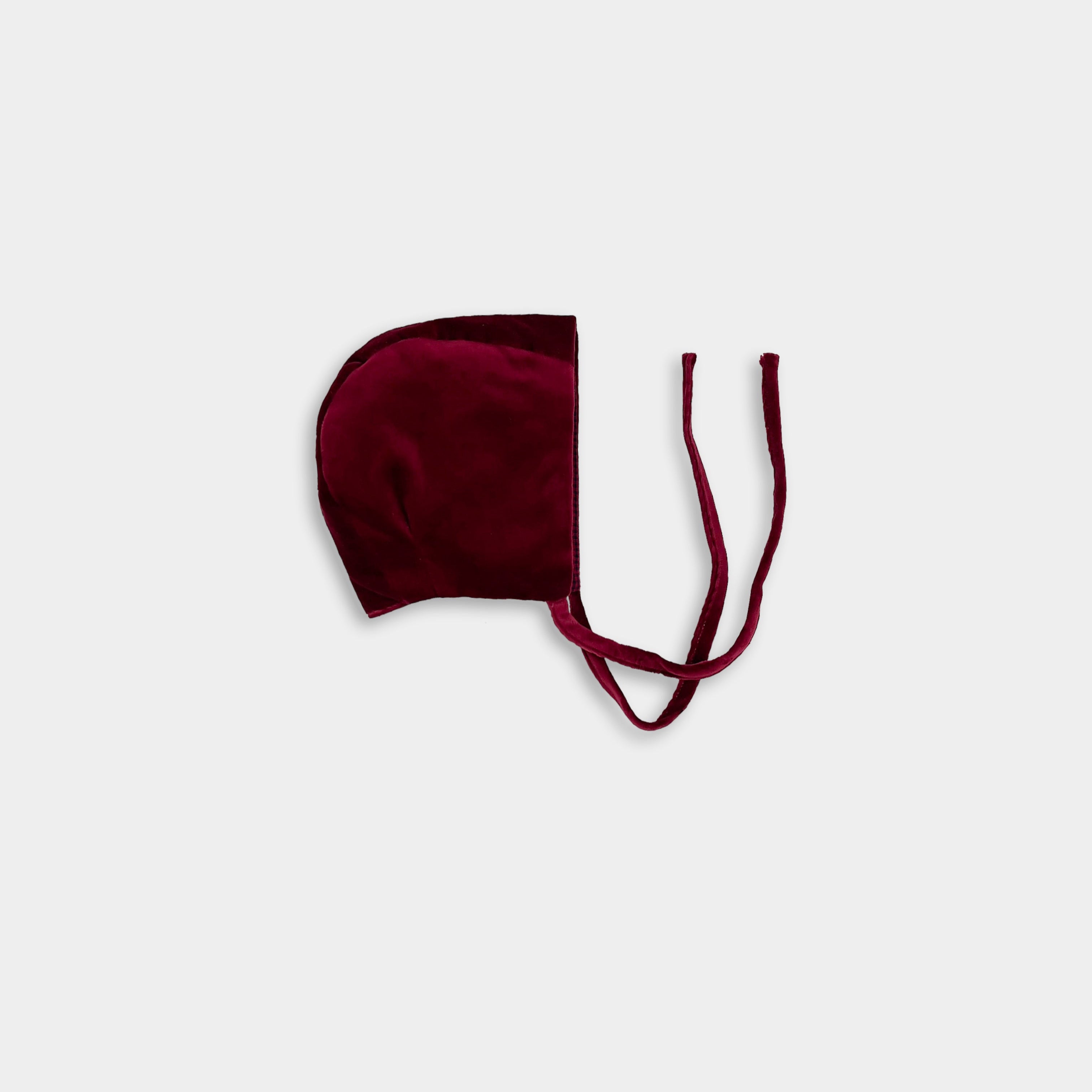 A wine velvet bonnet with a soft brushed interior, displayed against a white background.