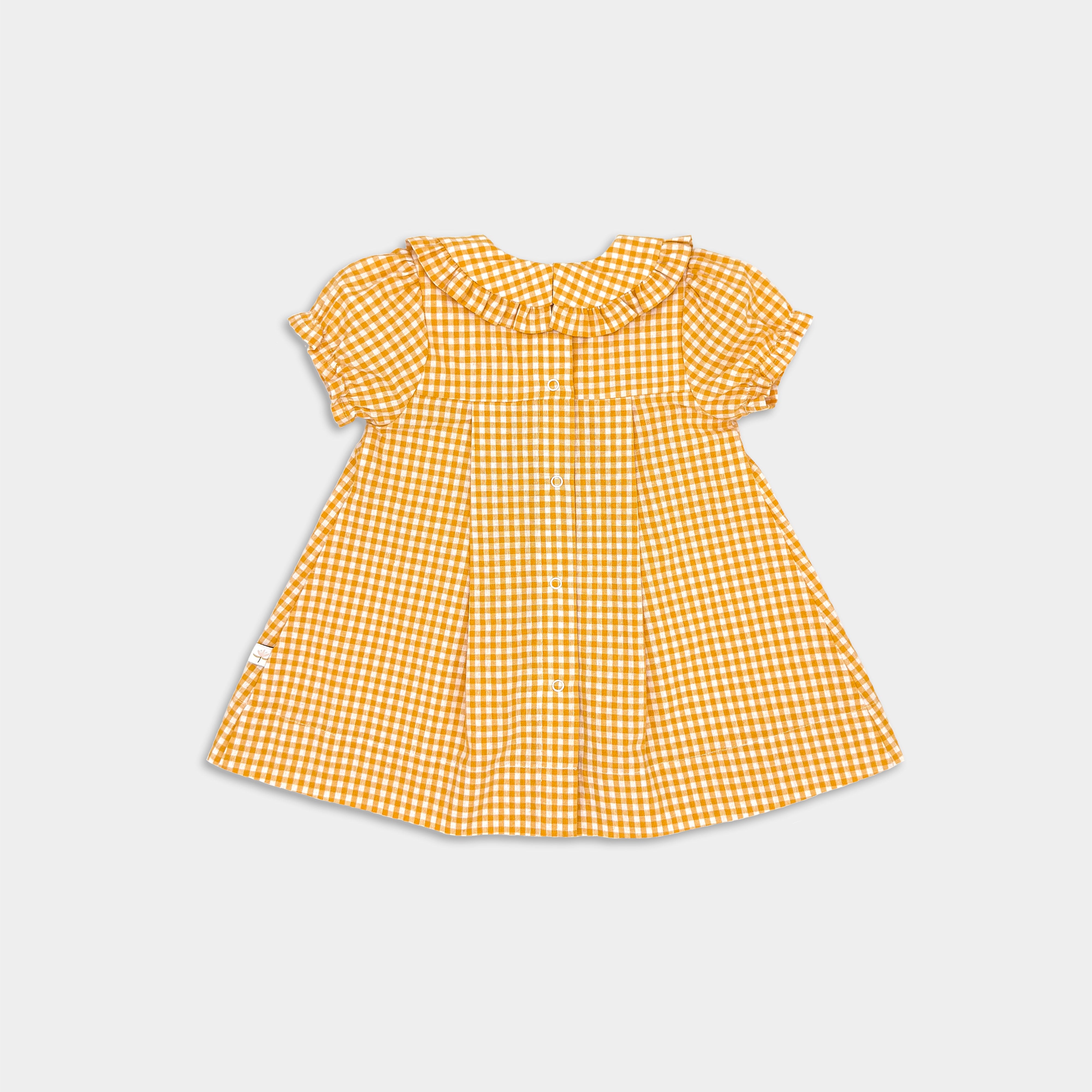 back of yellow gingham dress with pleats and ruffled collar and sleeves