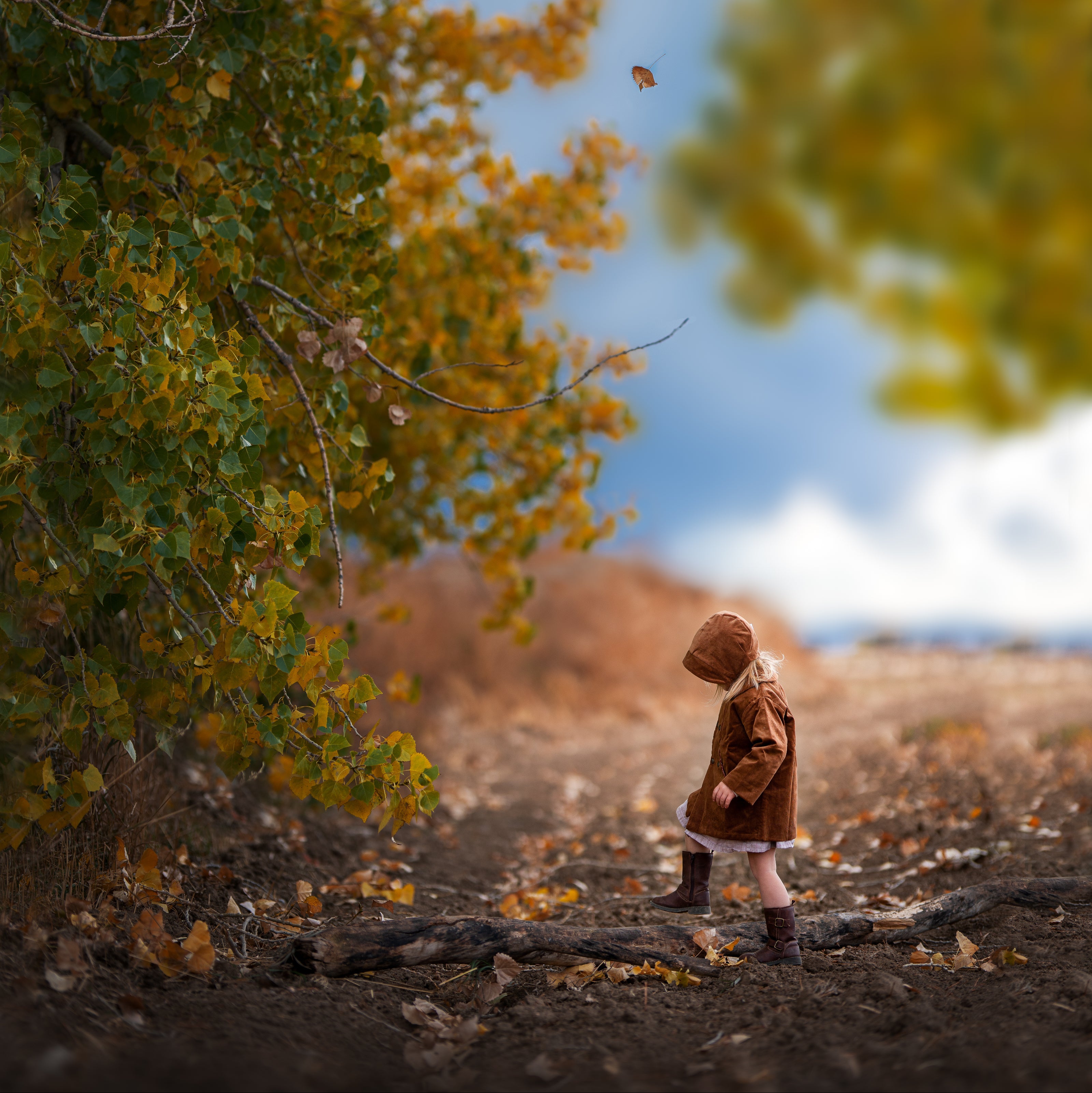 Model girl wearing the Camel Bonnet, profile view - This side angle showcases the shape and design of the bonnet, illustrating how it complements the model’s outfit and adds to her overall look.