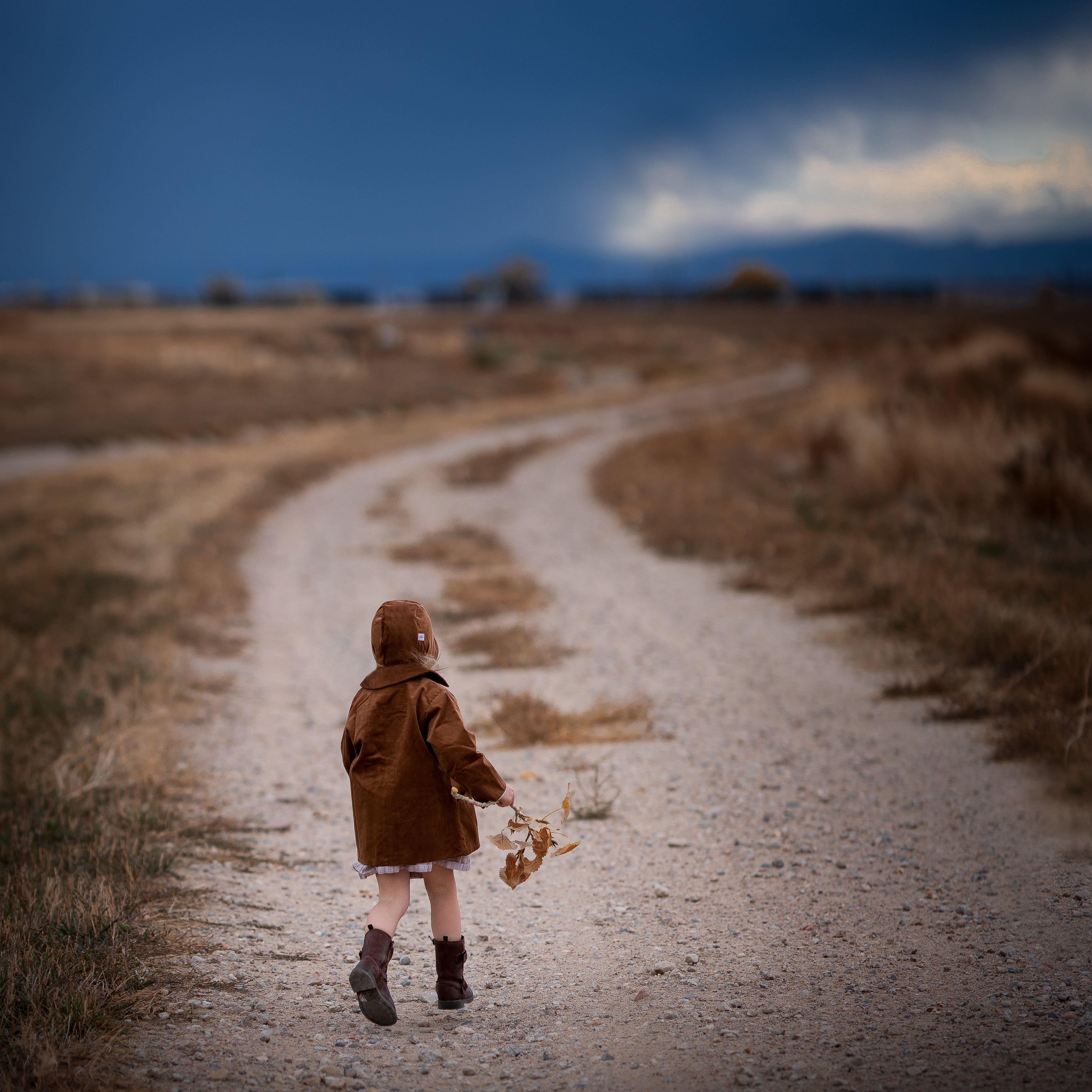 Model girl wearing the Camel Bonnet, back view - This image highlights the back of the bonnet, emphasizing the quality craftsmanship and fit, showcasing how it sits comfortably on the little girl’s head.