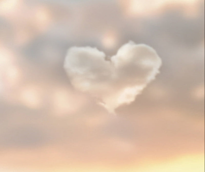 Heart-shaped cloud formation in a colorful sky