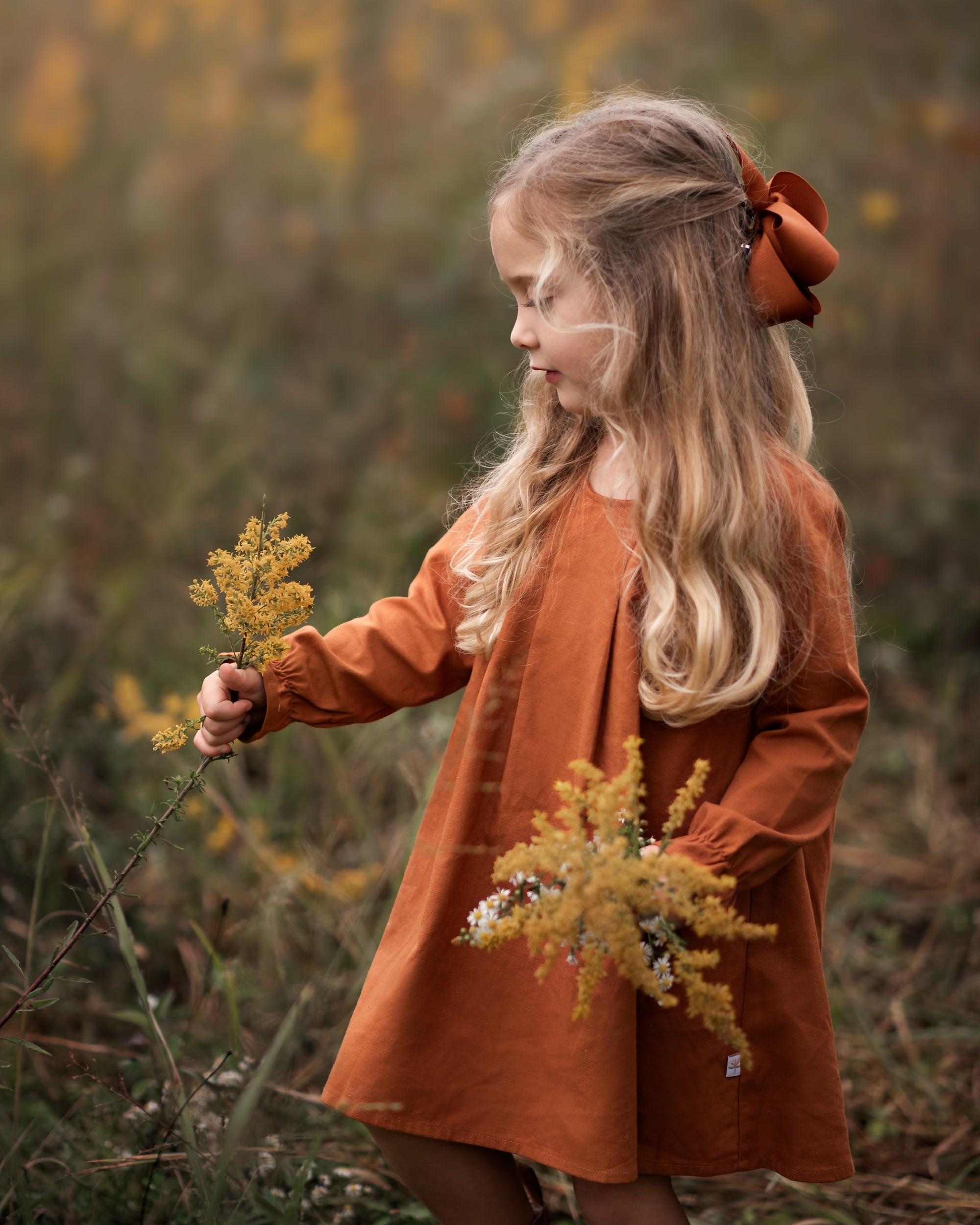 Model girl showcasing the front view of the dress - This image features a model wearing the dress from the front, highlighting the pin-tucked details and the flattering A-line shape.