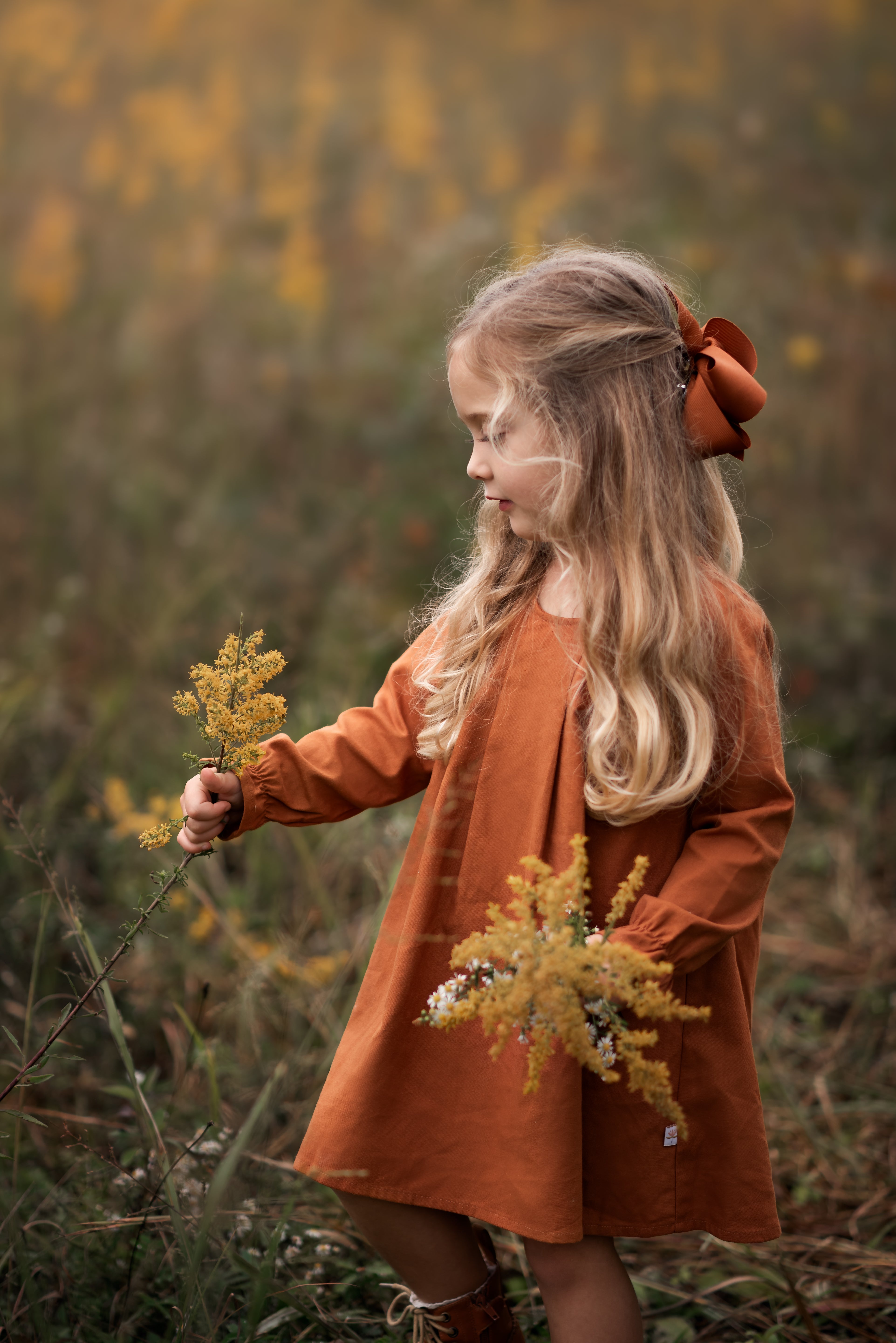 Model girl showcasing the front view of the dress - This image features a model wearing the dress from the front, highlighting the pin-tucked details and the flattering A-line shape.