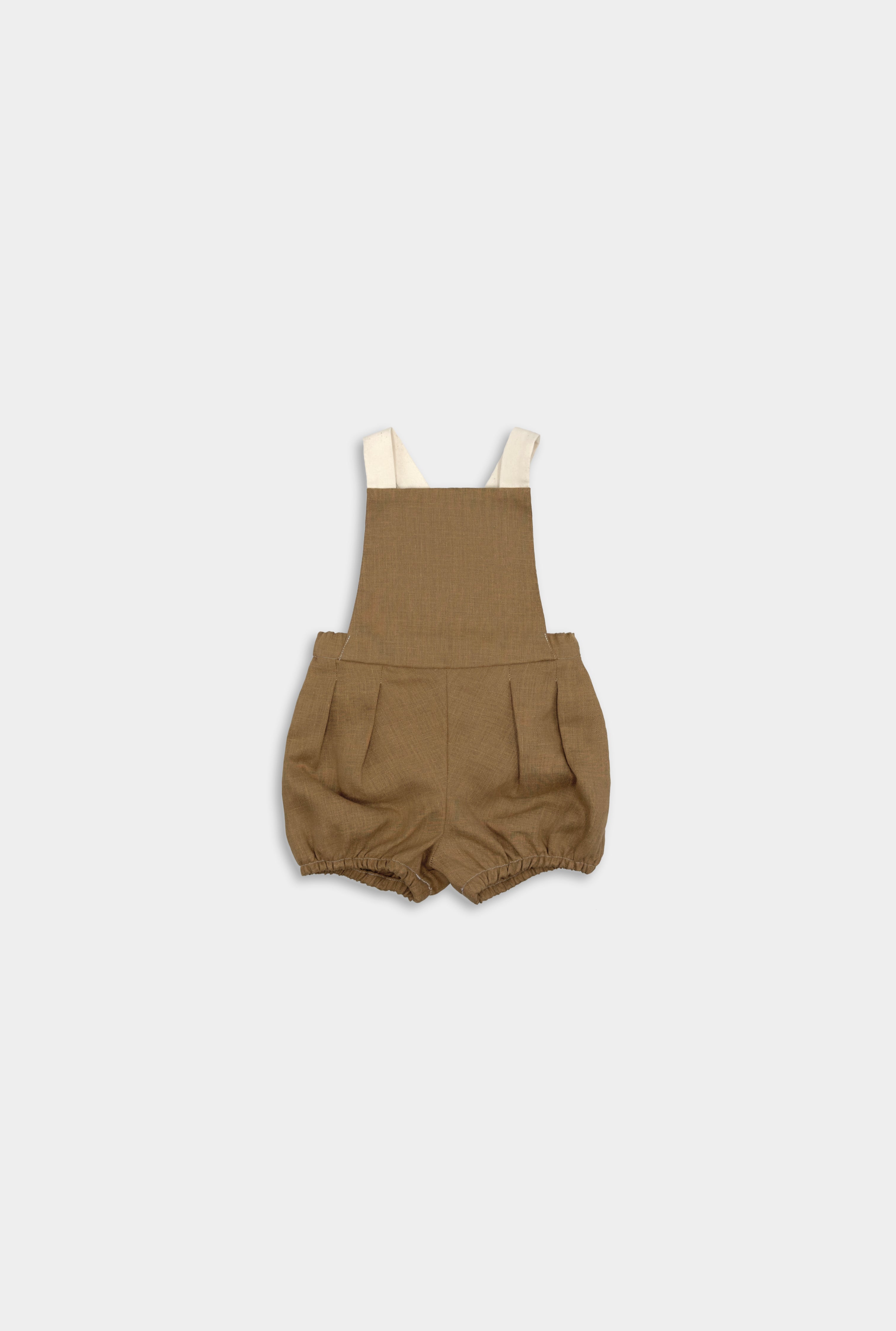 Front view of a handmade linen bubble romper in Beachwood, featuring adjustable contrasting straps in cream for a customizable fit and elasticized legs for easy movement during summer play. A gender-neutral design that combines timeless style with comfort, perfect for any occasion.