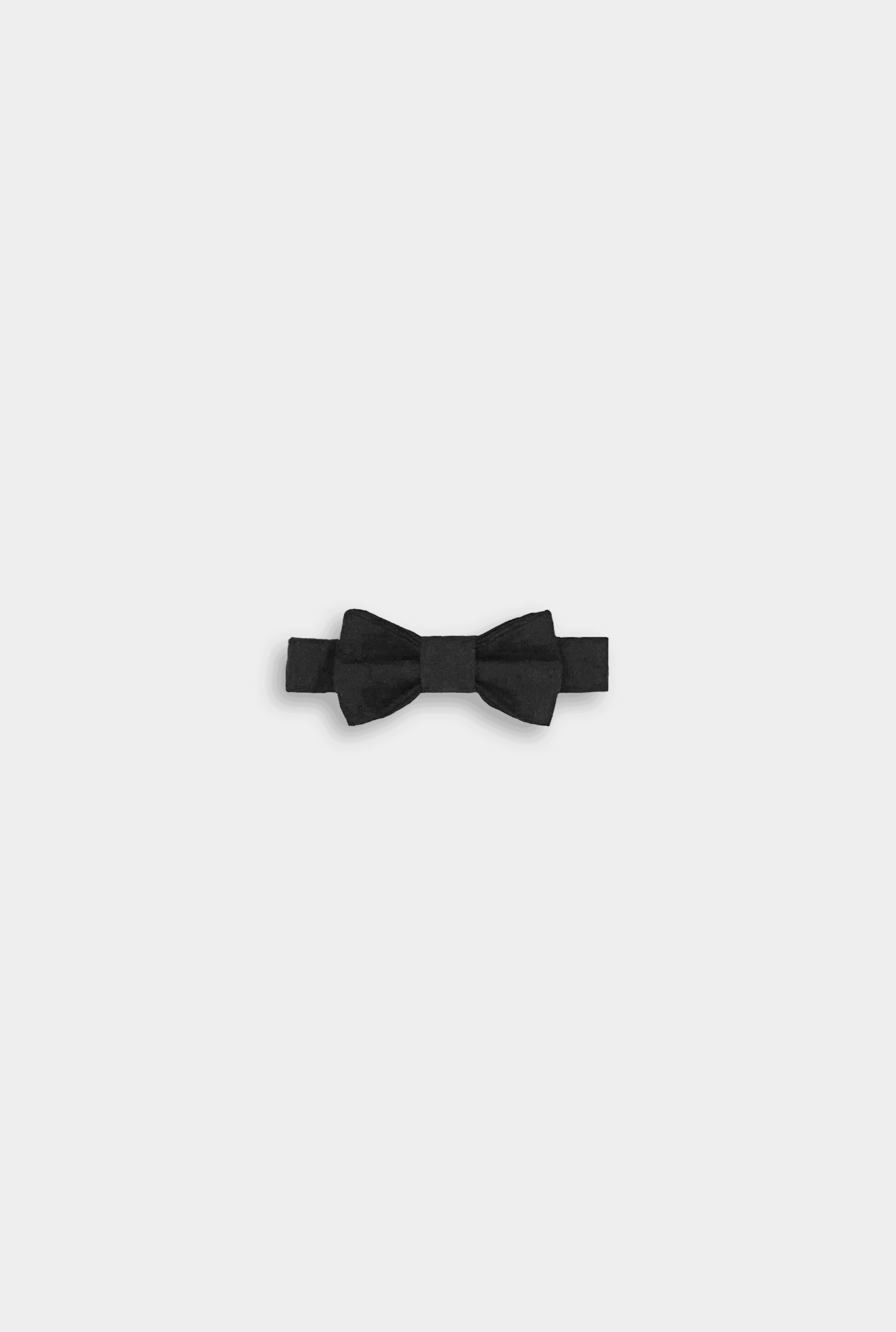 A black linen classic bow tie, featuring a timeless design, versatile for various outfits, available in two sizes for wearing over a shirt or on its own, and perfectly complementing bestselling suspender shorts and overalls.