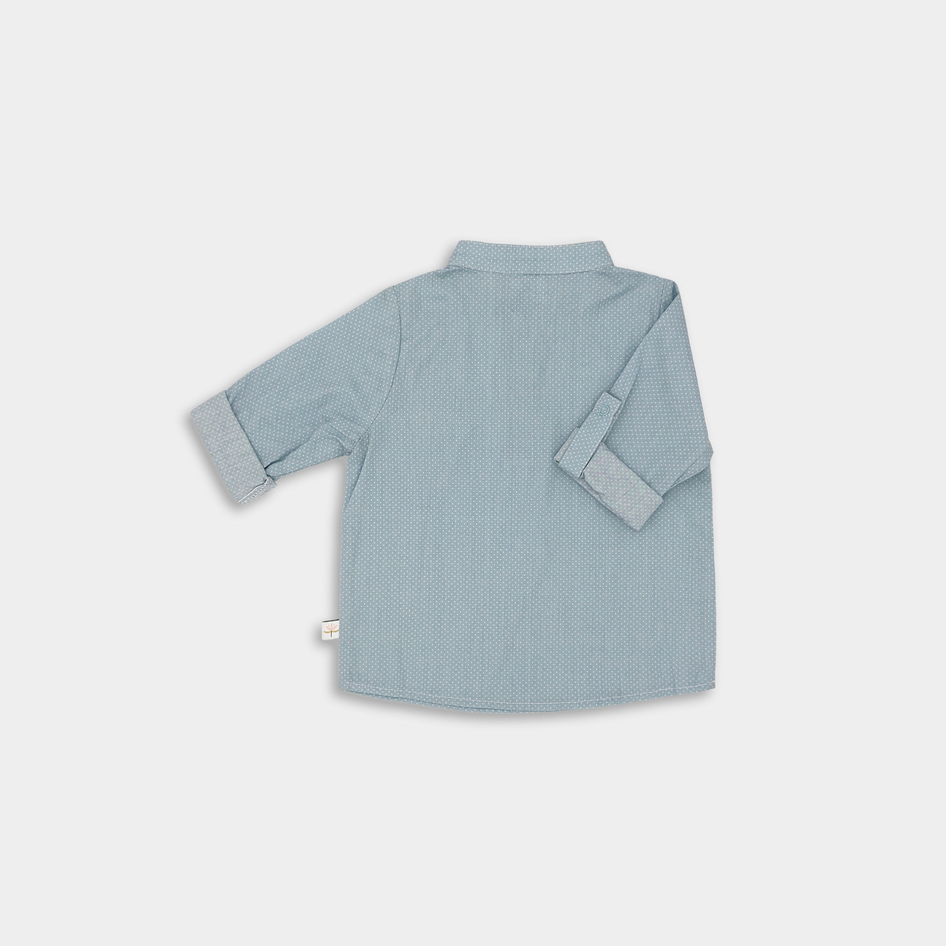 Back view of a classic light blue Henley shirt featuring white Swiss dots, crafted from natural, sustainable, and high-quality materials. It includes a timeless Henley placket for versatile wear and 3/4 cuffed sleeves that can be easily unrolled for layering, offering a stylish and functional addition to any outfit.