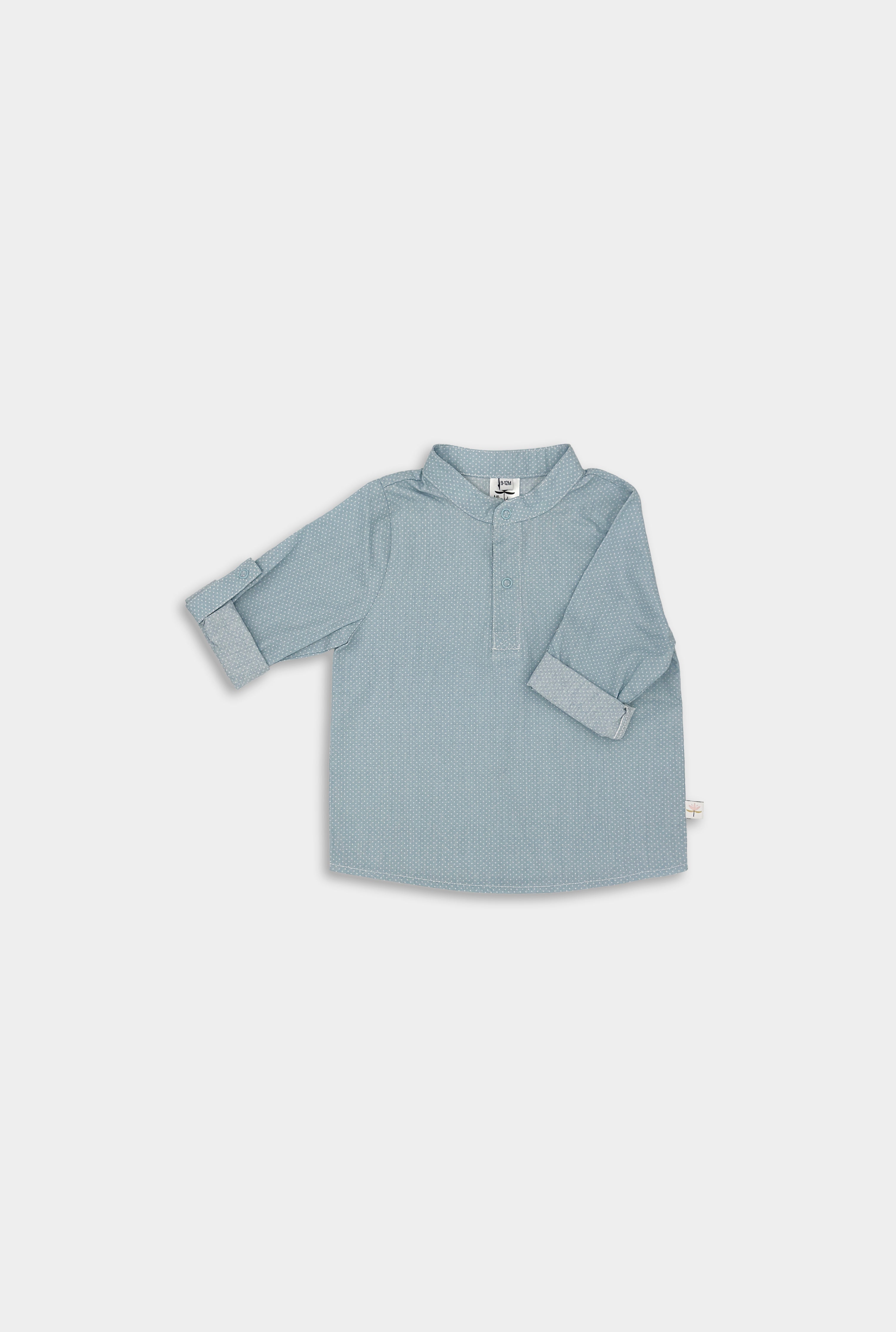 Front view of a classic light blue Henley shirt featuring white Swiss dots, crafted from natural, sustainable, and high-quality materials. It includes a timeless Henley placket for versatile wear and 3/4 cuffed sleeves that can be easily unrolled for layering, offering a stylish and functional addition to any outfit.
