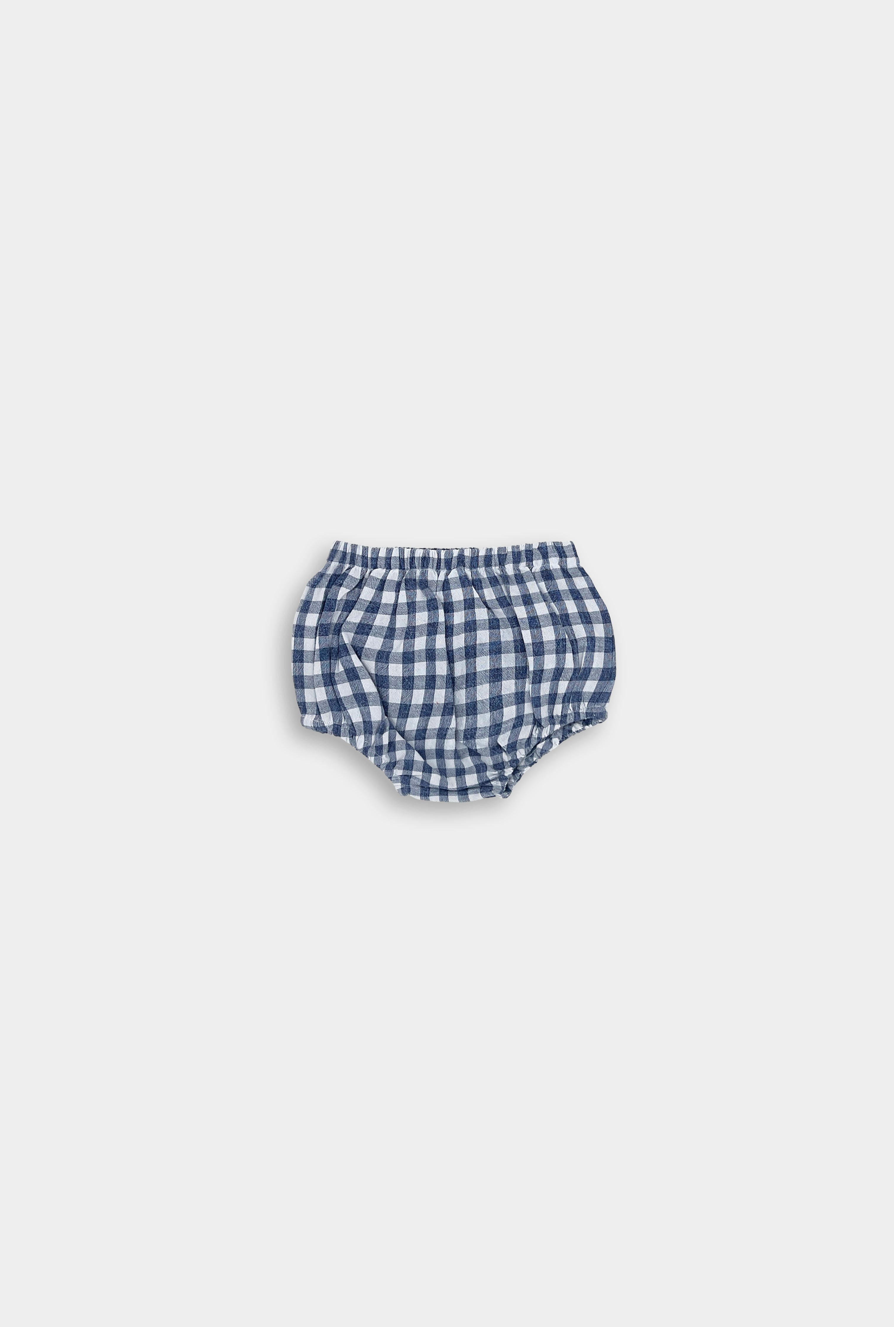 Sustainable blue gingham linen bloomers for babies made from a soft cotton-linen blend. Breathable and lightweight, these bloomers are a wardrobe essential and pair perfectly with our dresses for an eco-friendly look.