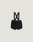 Black baby boy's shorts with adjustable shoulder straps and silver snap buttons, laid flat on a light gray background.