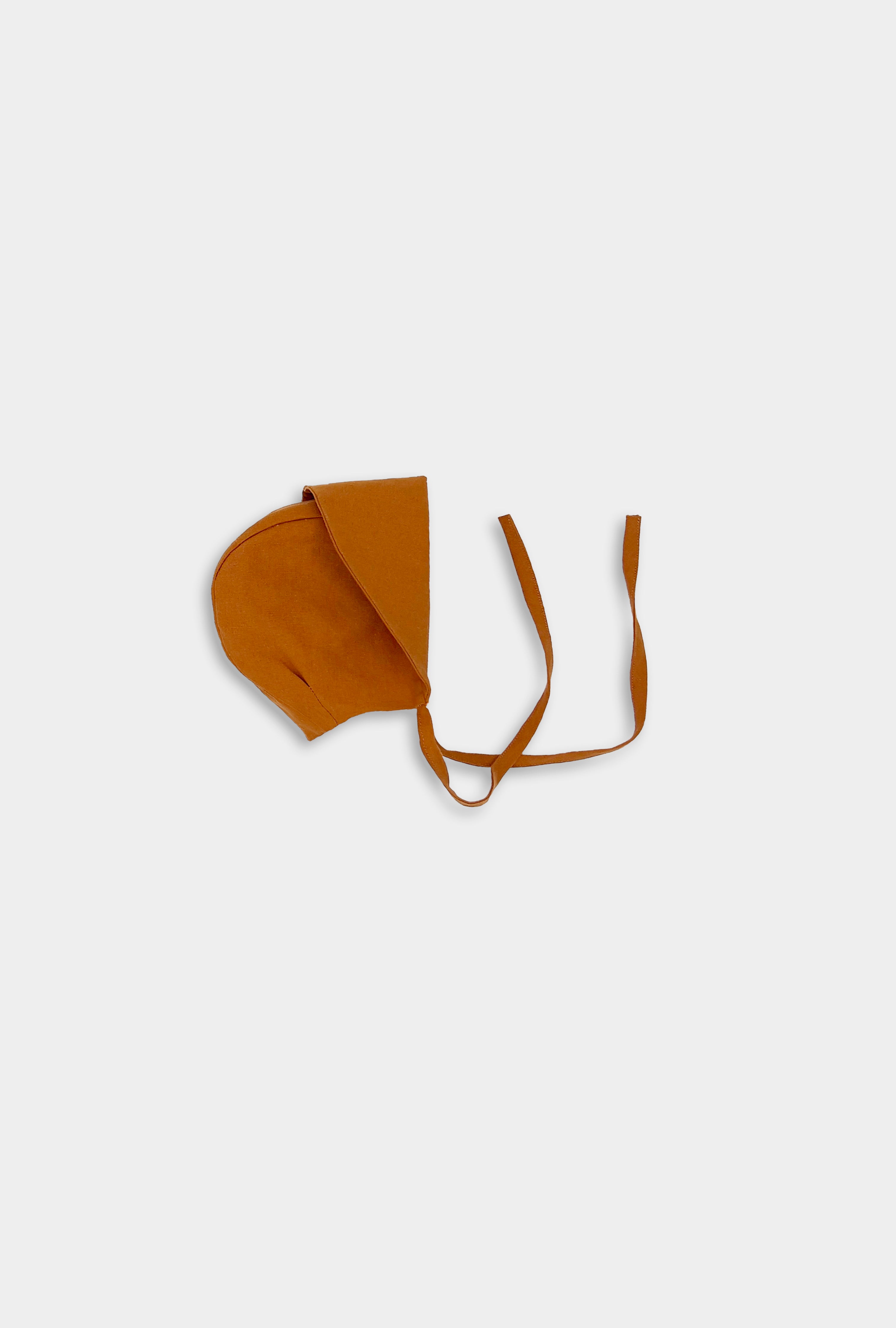 Photo of the Burnt Orange Sunbonnet with brim folded - This image showcases the sunbonnet with the brim folded up, highlighting its elegant design and versatility as a stylish accessory.