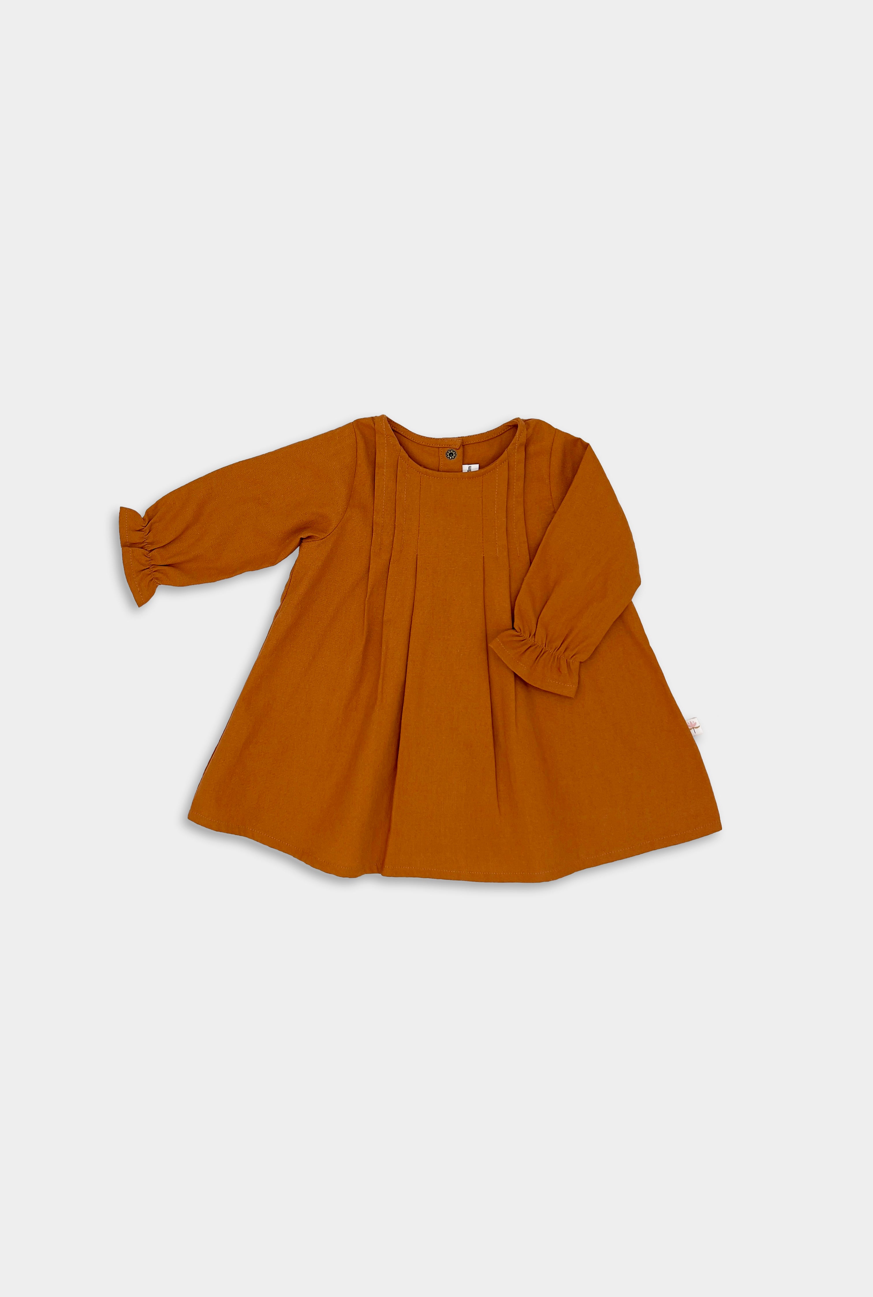 Photo of the Burnt Orange Linen Dress alone - This image showcases the elegant long sleeve design of the dress, highlighting its earthy color and overall silhouette.