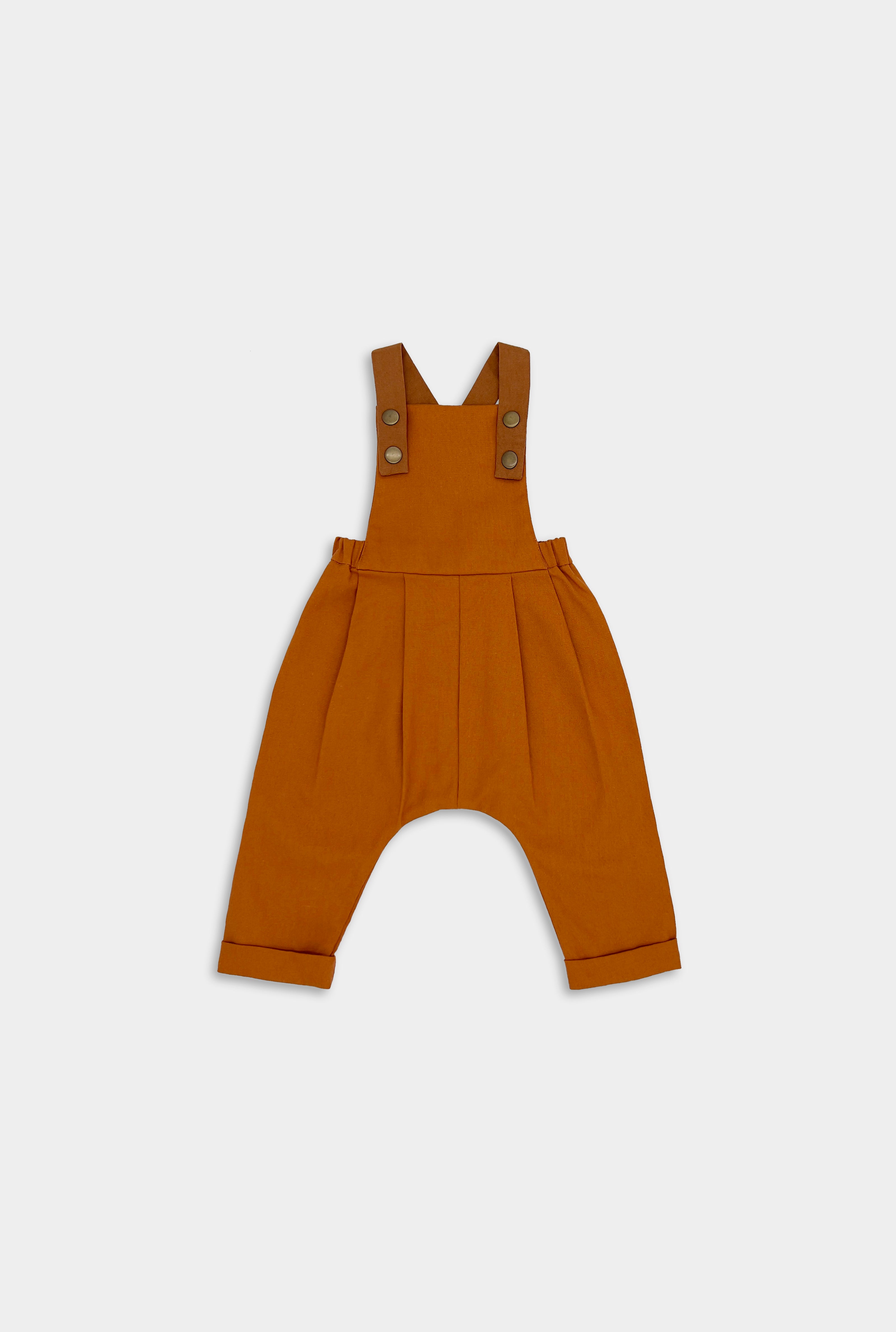 Close-up of Burnt Orange Linen Overalls - This image highlights the rich color and quality fabric of the overalls, showcasing their timeless and photogenic appeal