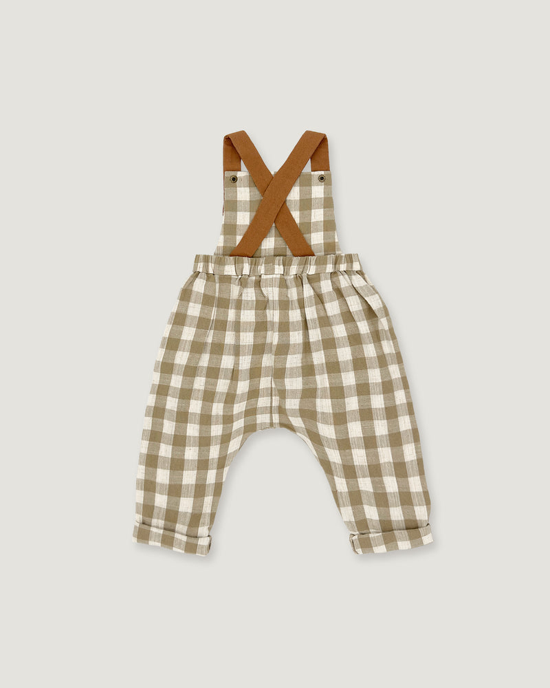 A baby romper with brown suspenders featuring a beige and white gingham check pattern, laid flat on a light gray background.